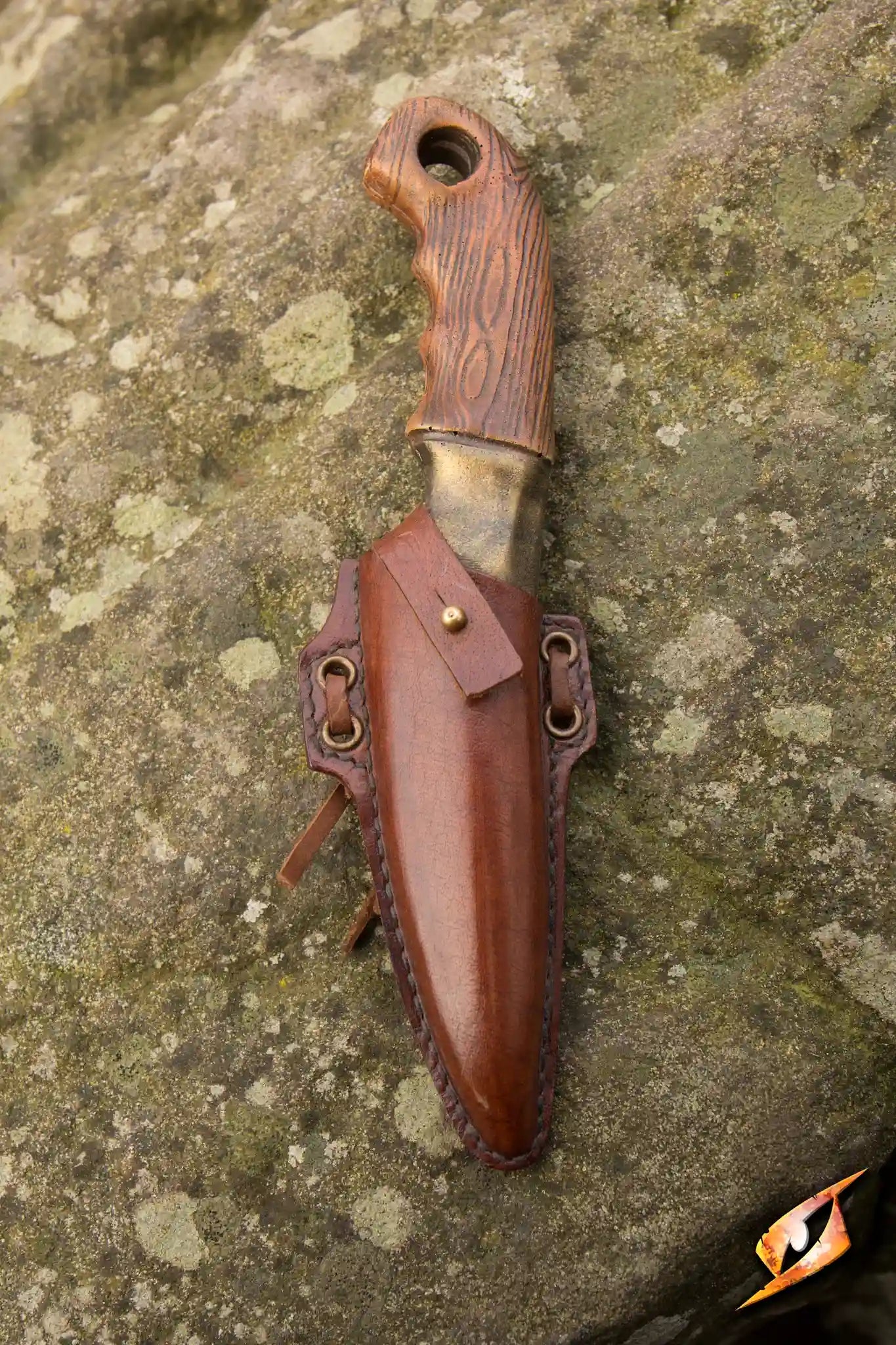 Woodsman Knife & Holder featuring a handmade brown leather holder with a secured knife, perfect for outdoor adventures.