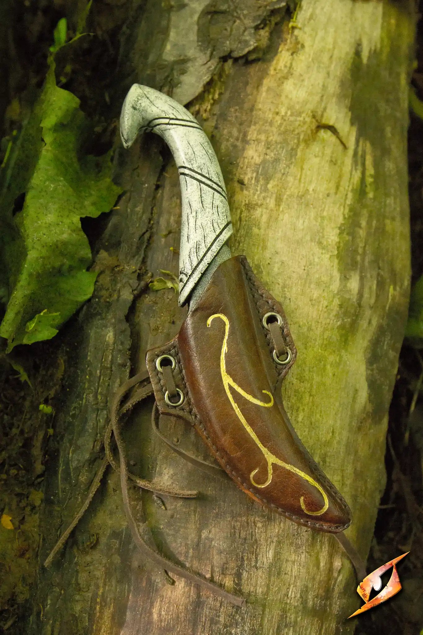 Elven Throwing Knife & Holder displayed on a tree trunk surrounded by foliage.