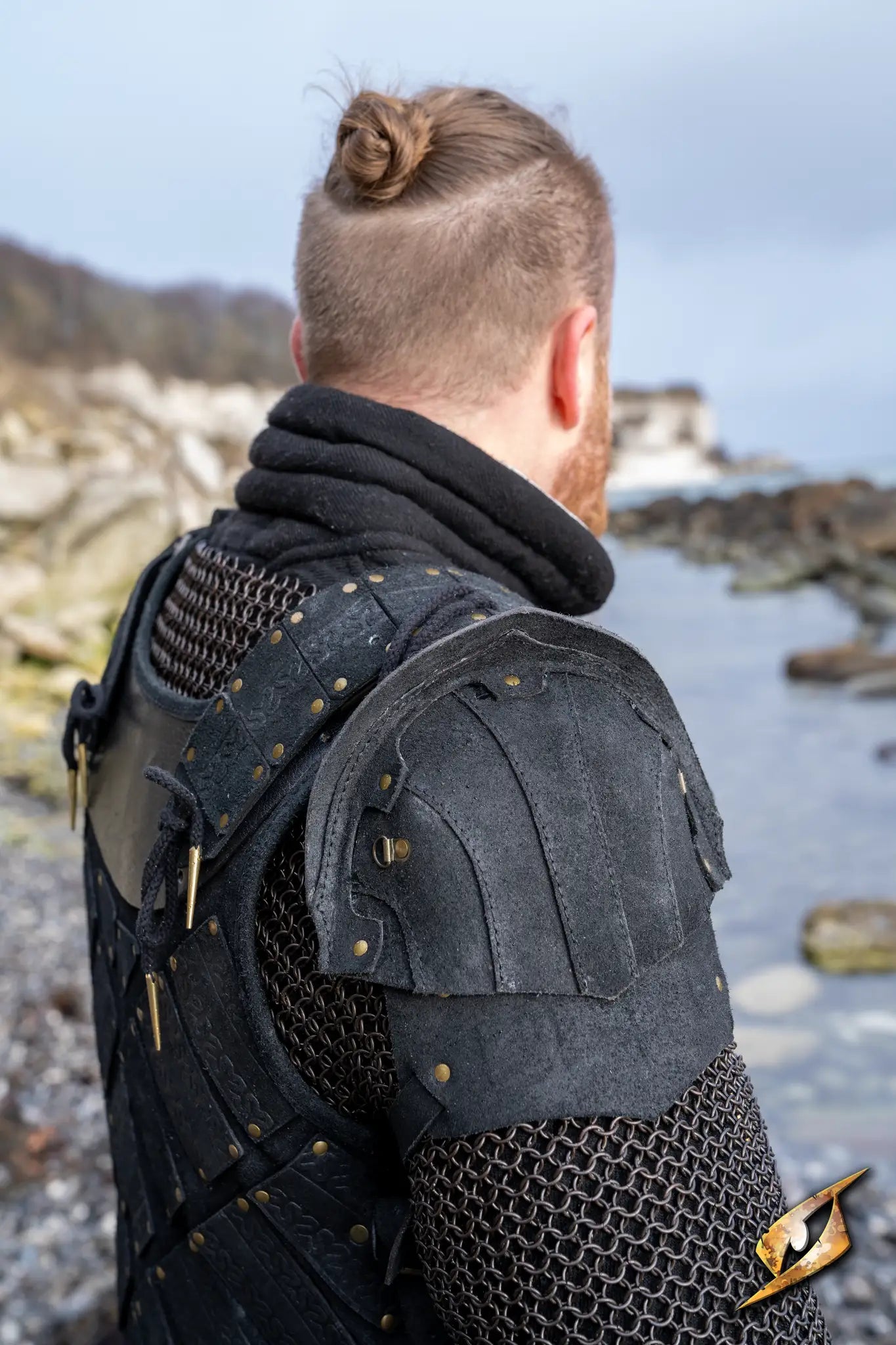 Woodsman Suede Shoulder Armour displayed in a scenic outdoor setting, showcasing its epic design and authentic detailing.