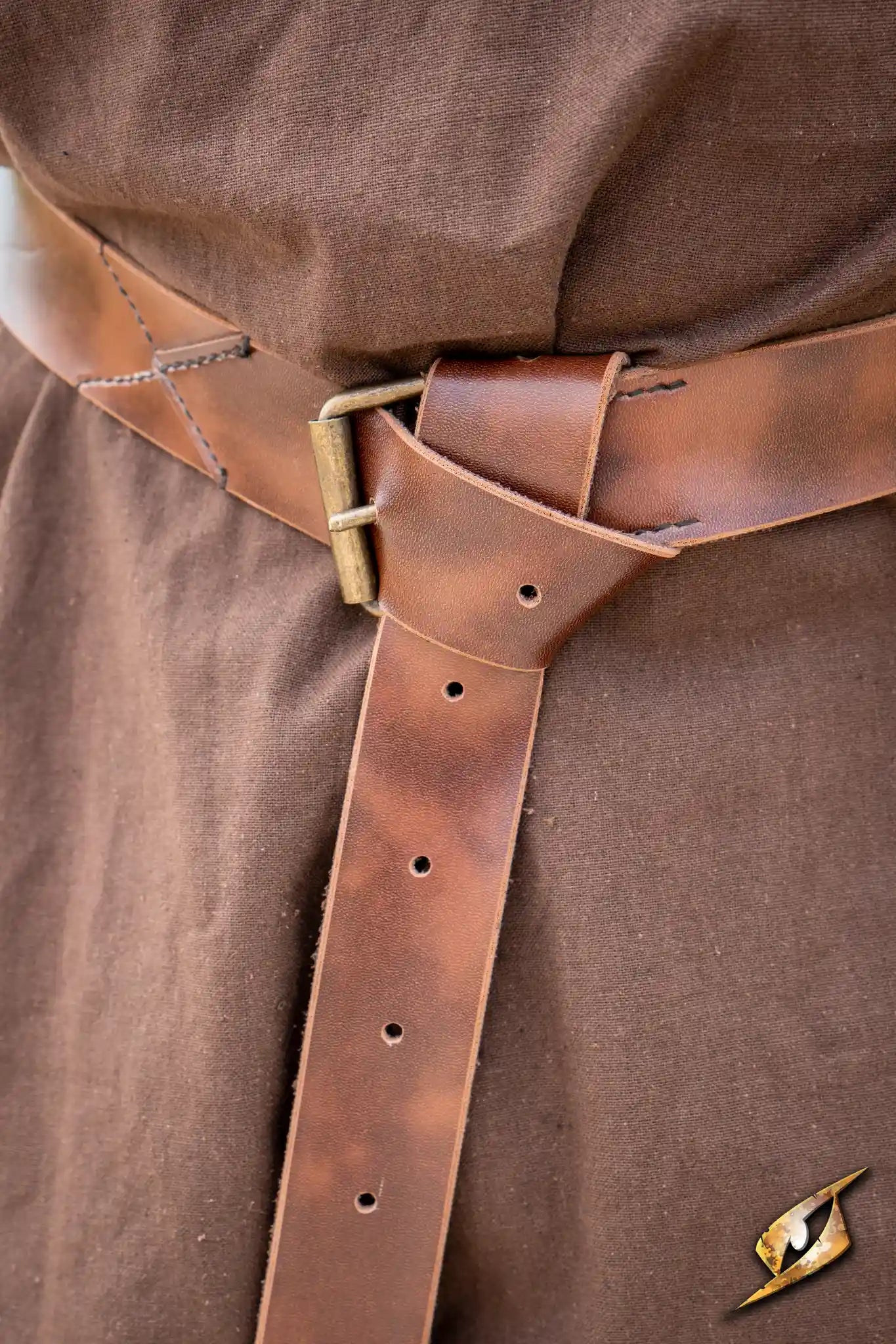 X Belt - Faux Leather styled on a brown tunic, featuring a buckle and adjustable holes for a secure fit.