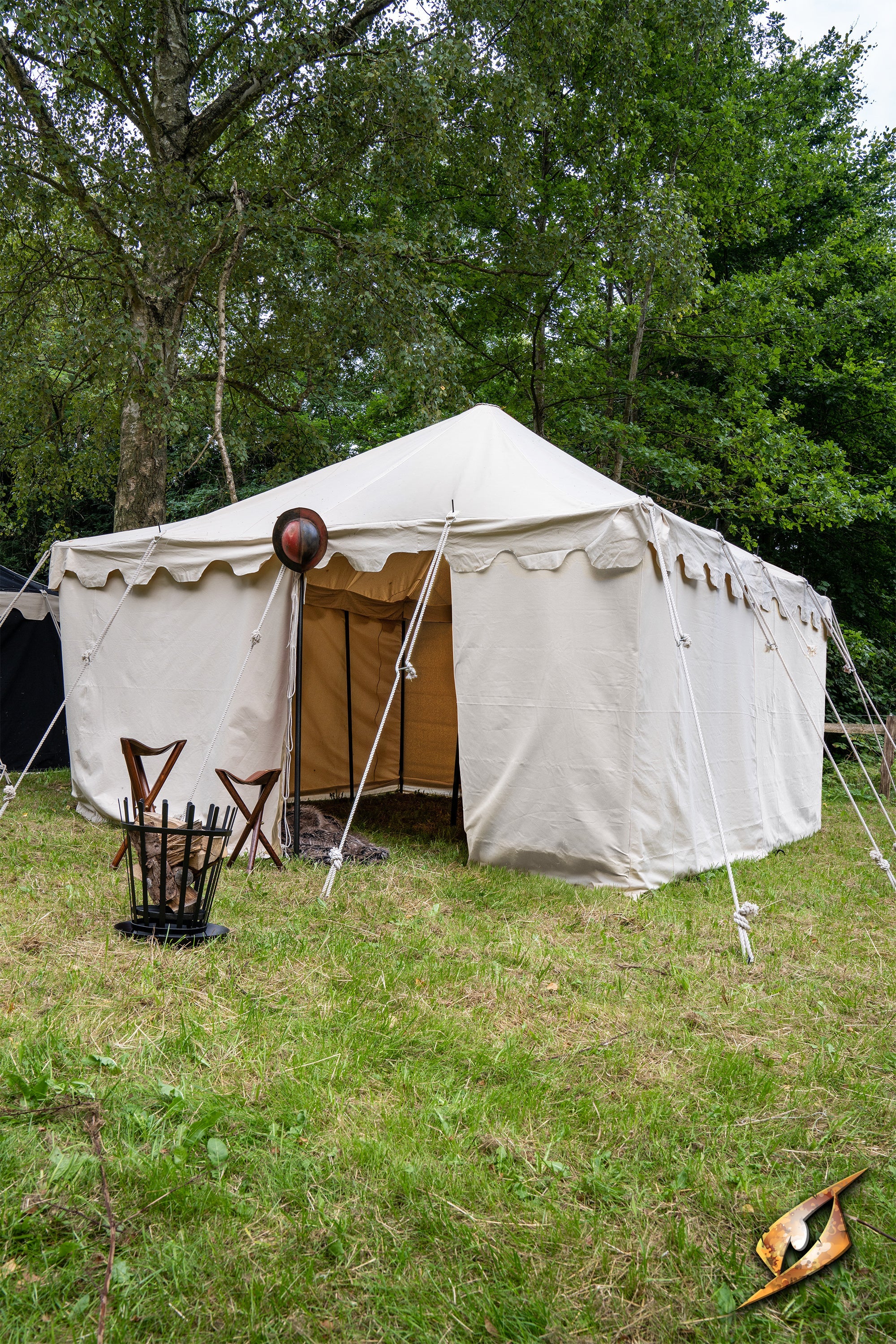 Marquee Tent - 4x4m set up in a grassy area with chairs outside under trees.
