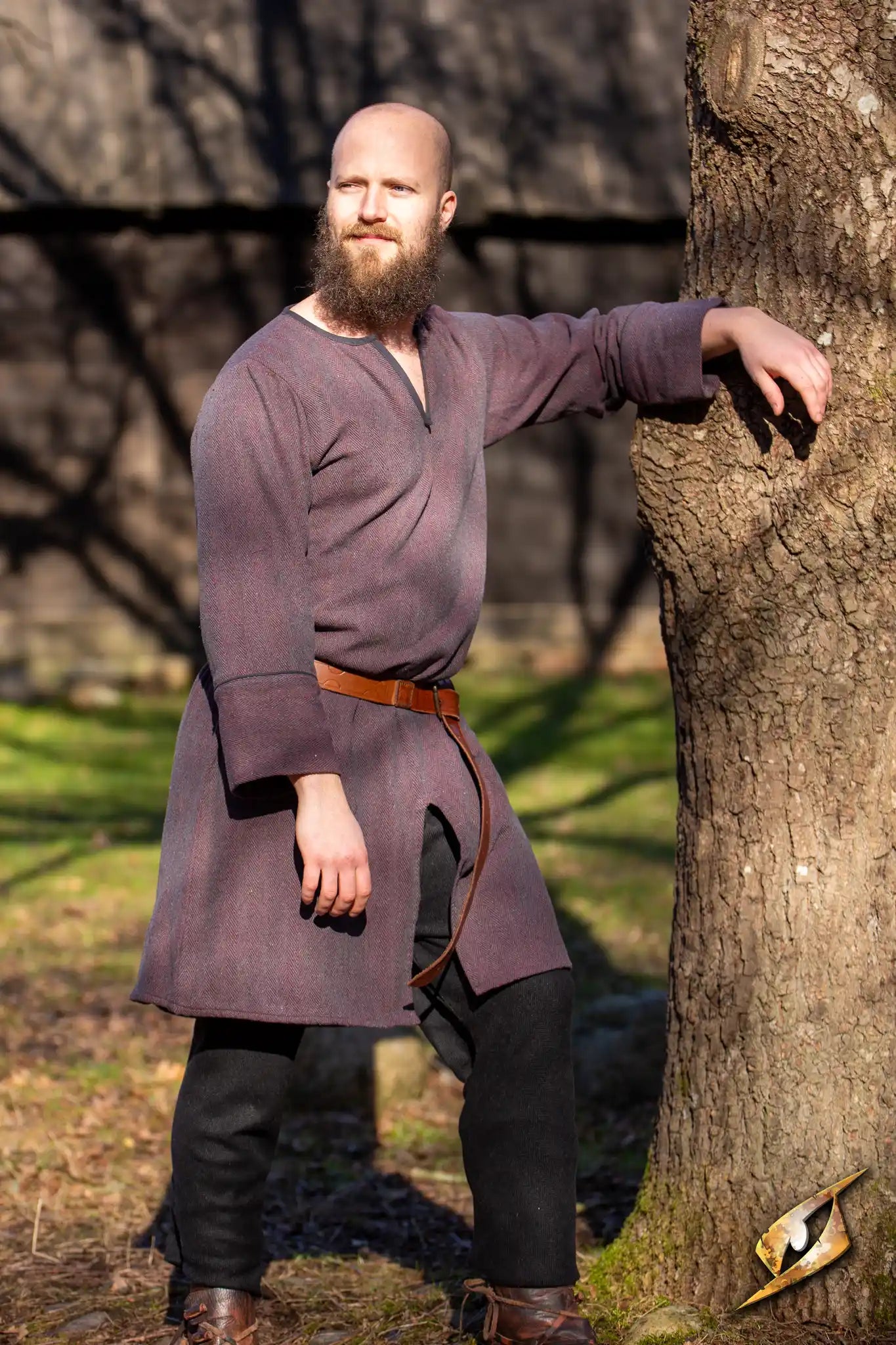 Woodland Tunic in burgundy gray, featuring a split crew neckline and tapered edges, worn by a bearded man outdoors.
