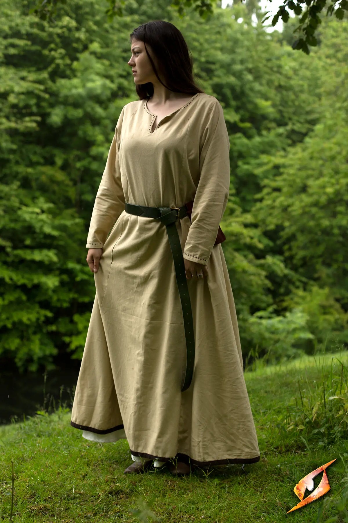 A model wearing a Basic Dress in a natural setting, showcasing comfort and elegance amidst greenery.