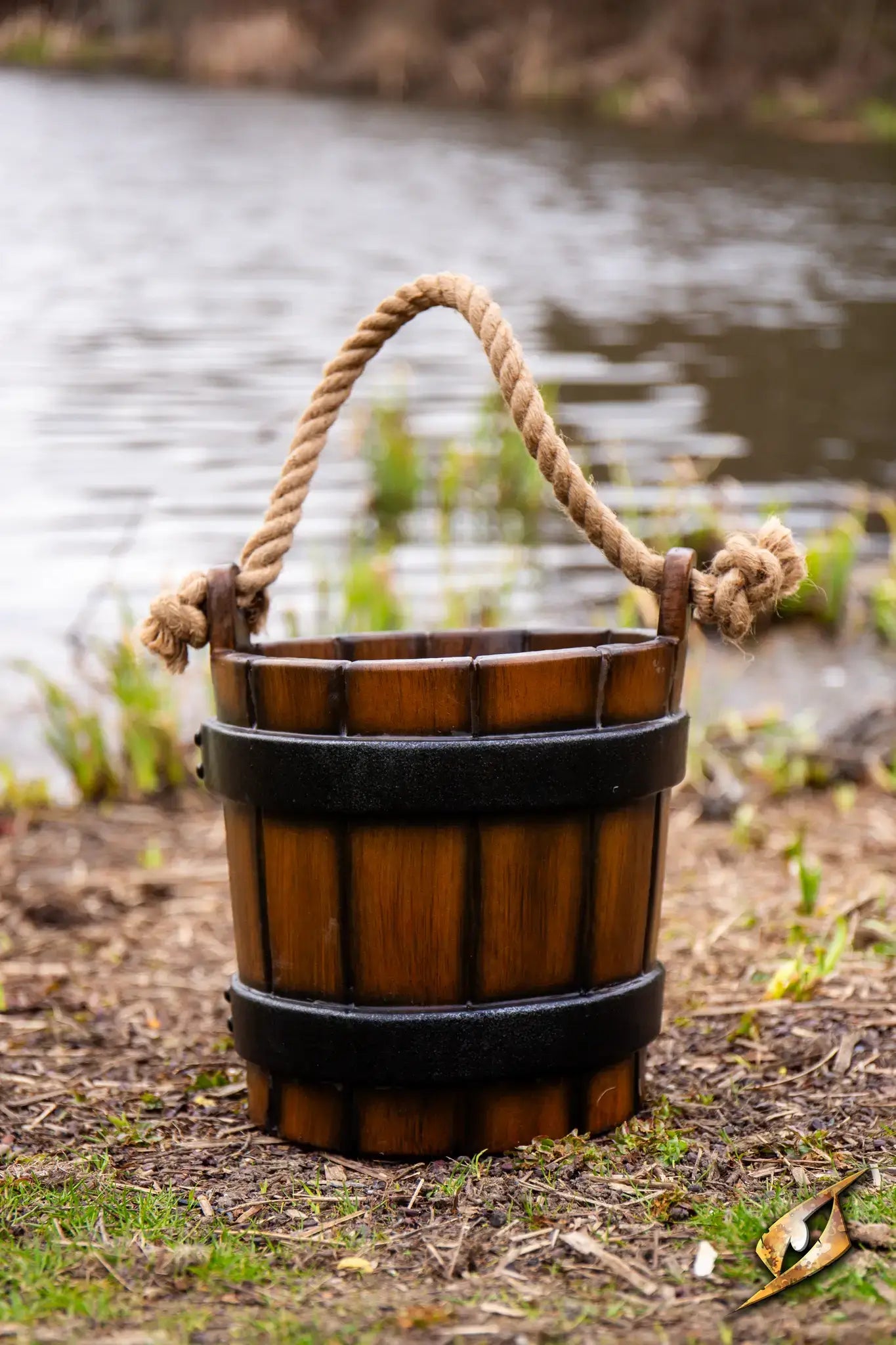 Water Bucket crafted with realistic wooden texture and rope handle, perfect for medieval themed activities and decorations.