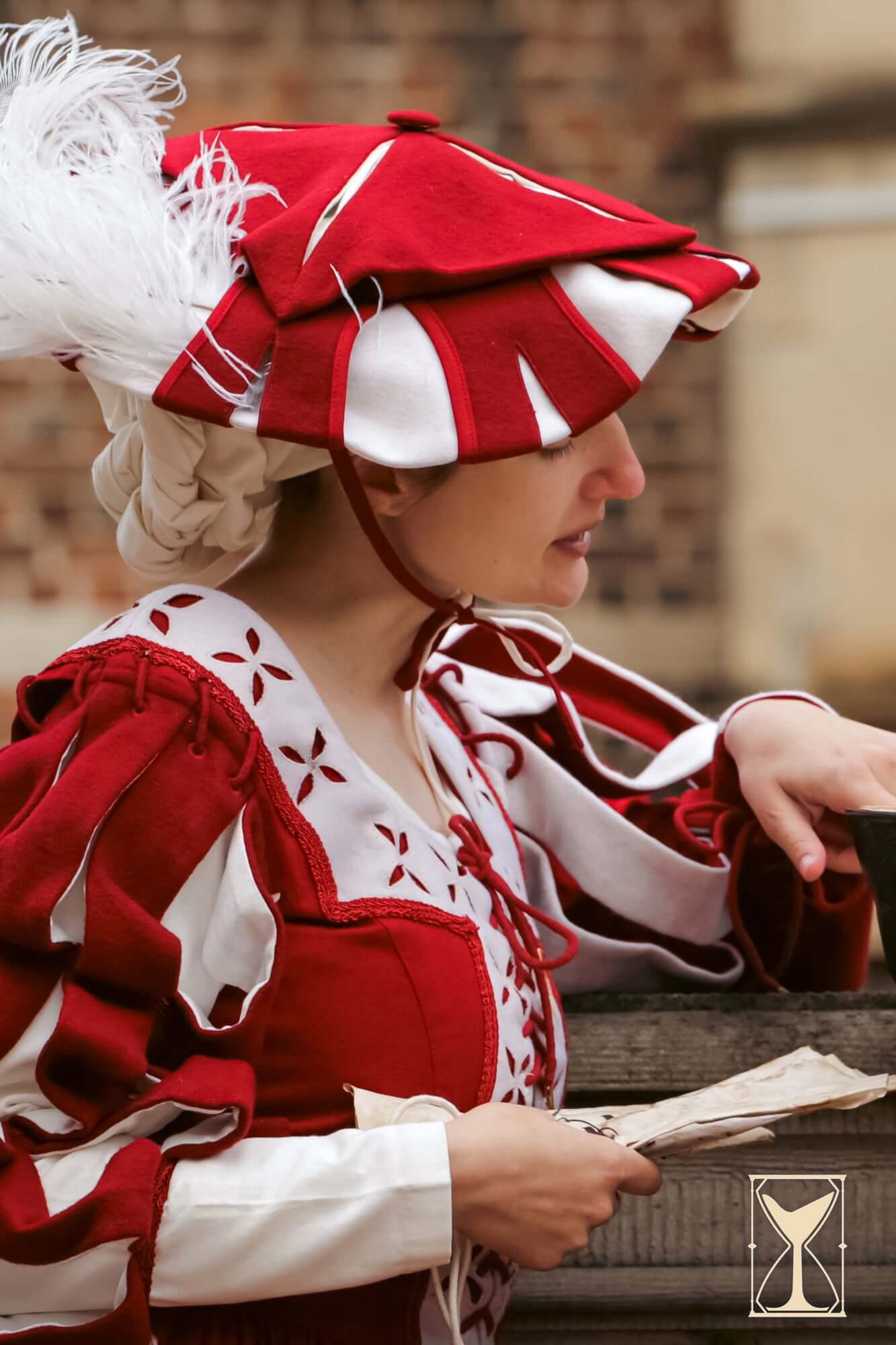 Landsknecht Hat worn by a woman in a historical costume, showcasing bold colors and layered design.