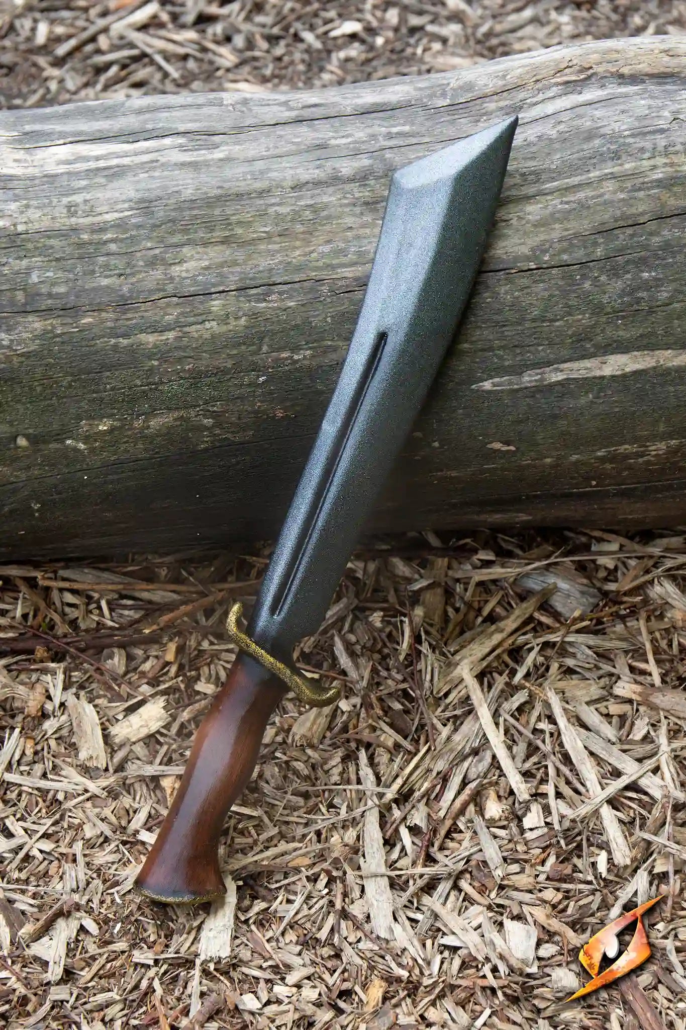 Bowie - 46 cm knife displayed on a log, showcasing its imposing blade and gold cross-guard.