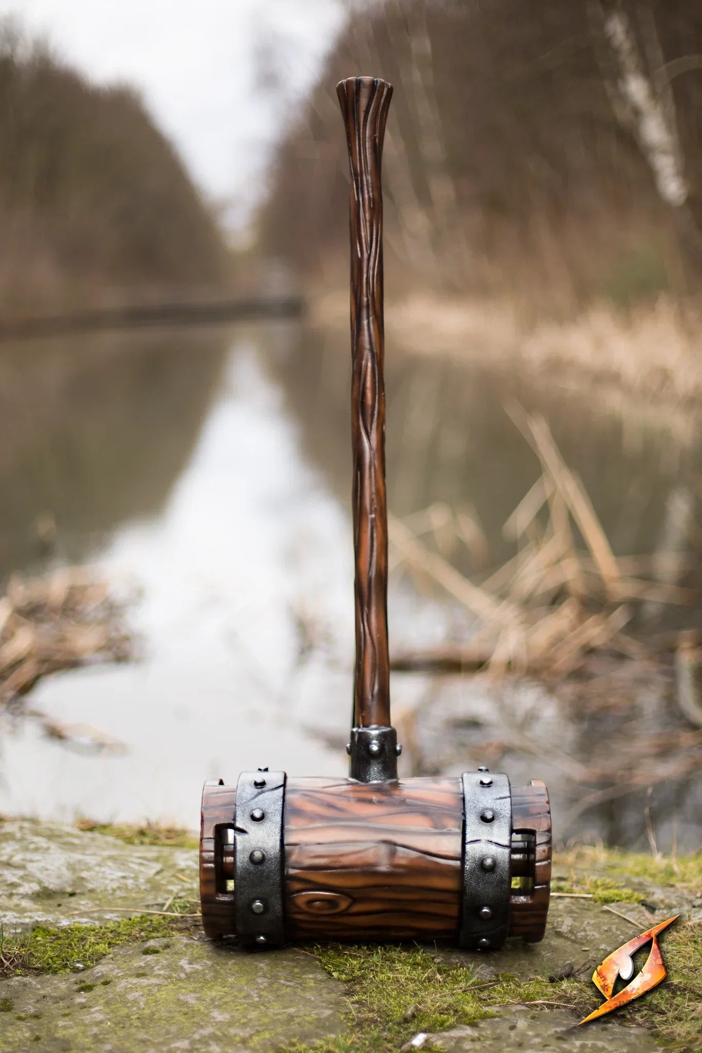 Epic Armoury War Mallet on a riverbank, showcasing its detailed design and lightweight construction.
