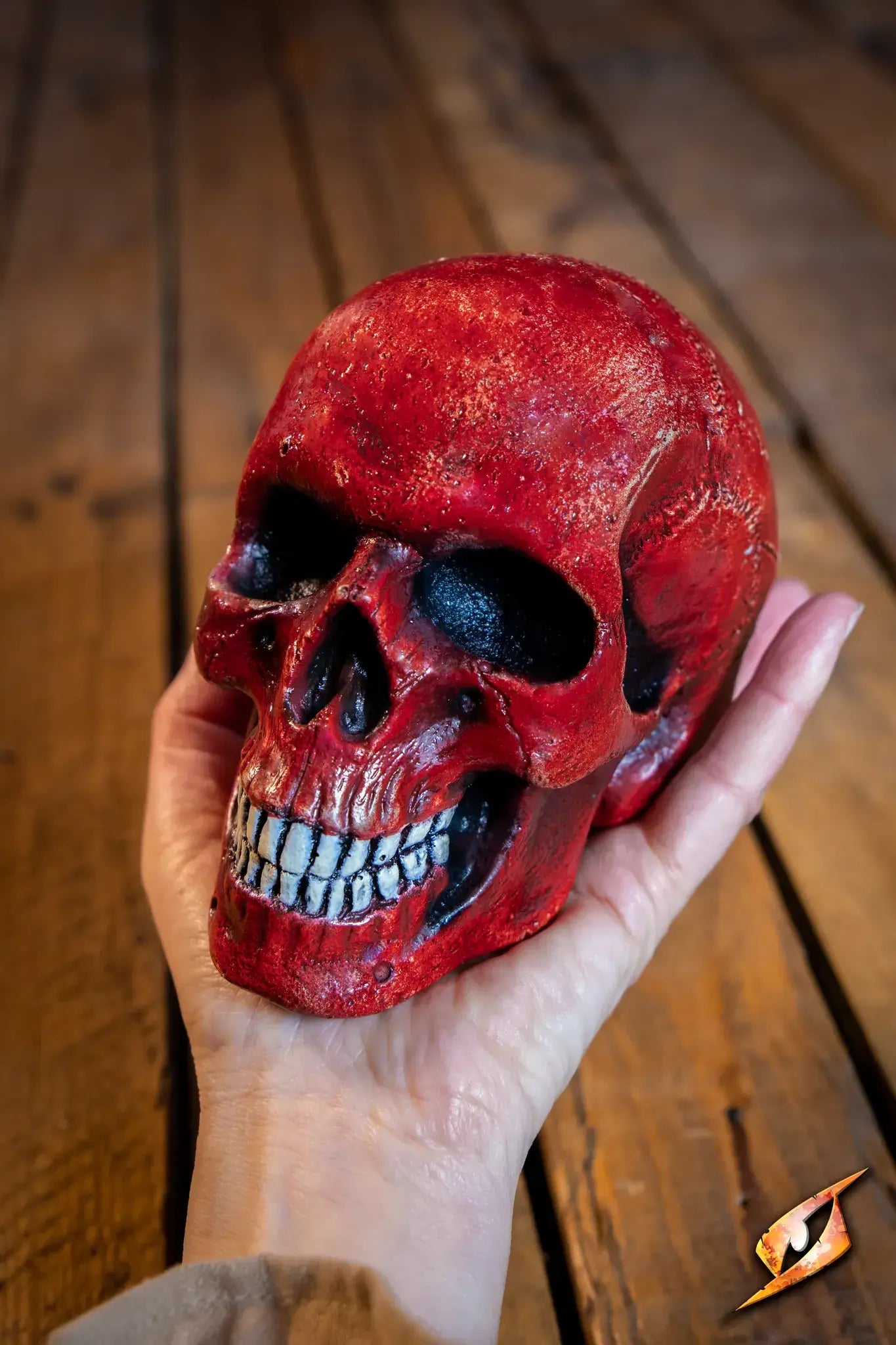 Medium Skull held in hand, featuring vibrant red color and intricate detailing, perfect for necromancer-themed decor.