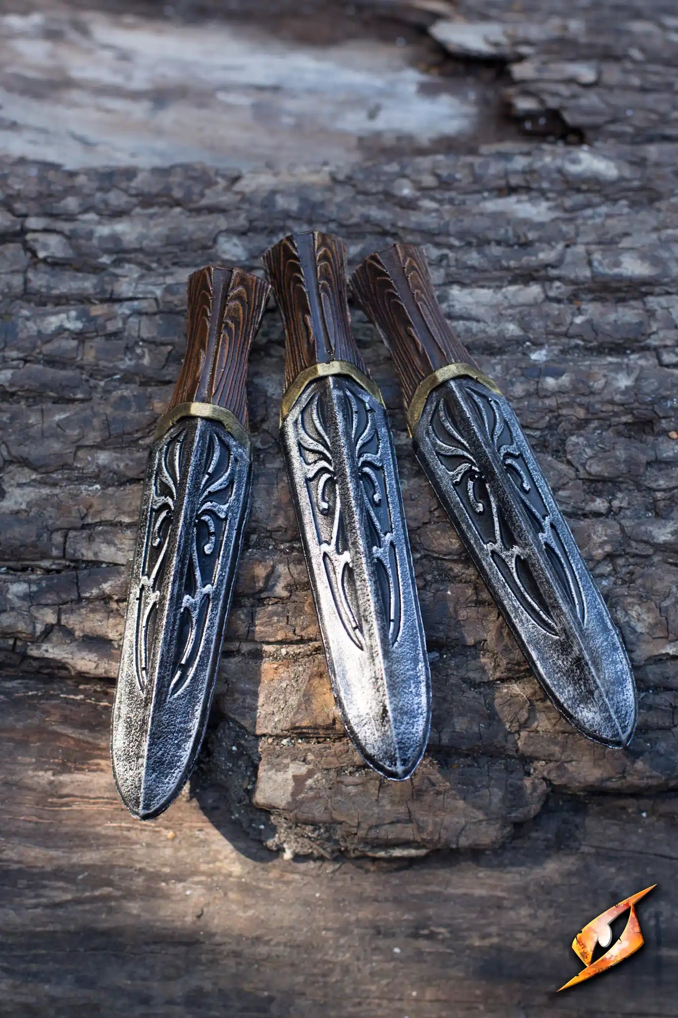 Assassin Unity Knives - 13 cm - 3 pcs displayed on wood background, showcasing intricate designs and craftsmanship.