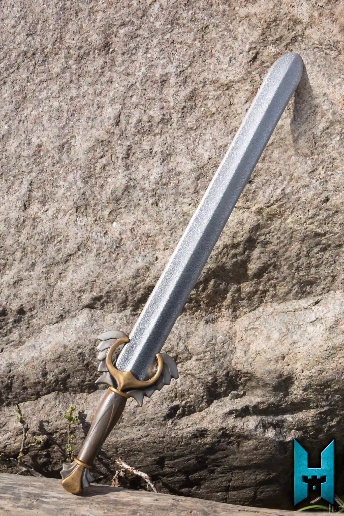 Angelic Sword resting on a rocky surface, showcasing its elegant design and noble craftsmanship.