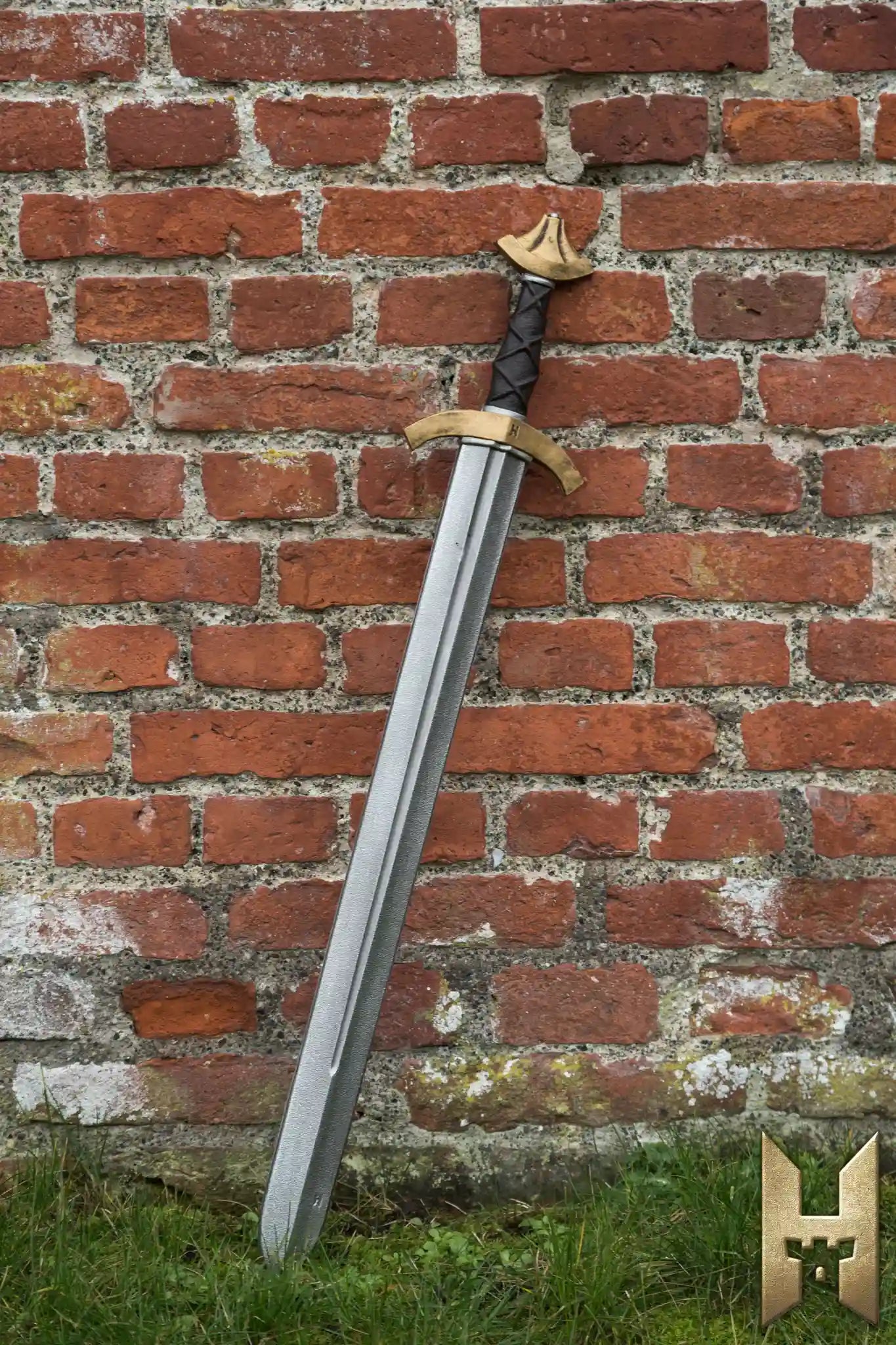 Arming Sword leaning against a brick wall, showcasing its historical design and foam material for LARP battles.