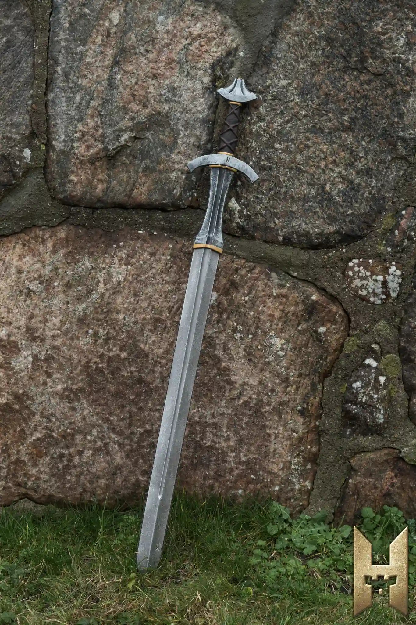 Arming Sword resting against a stone wall, showcasing its historical design and foam construction for LARP battles.