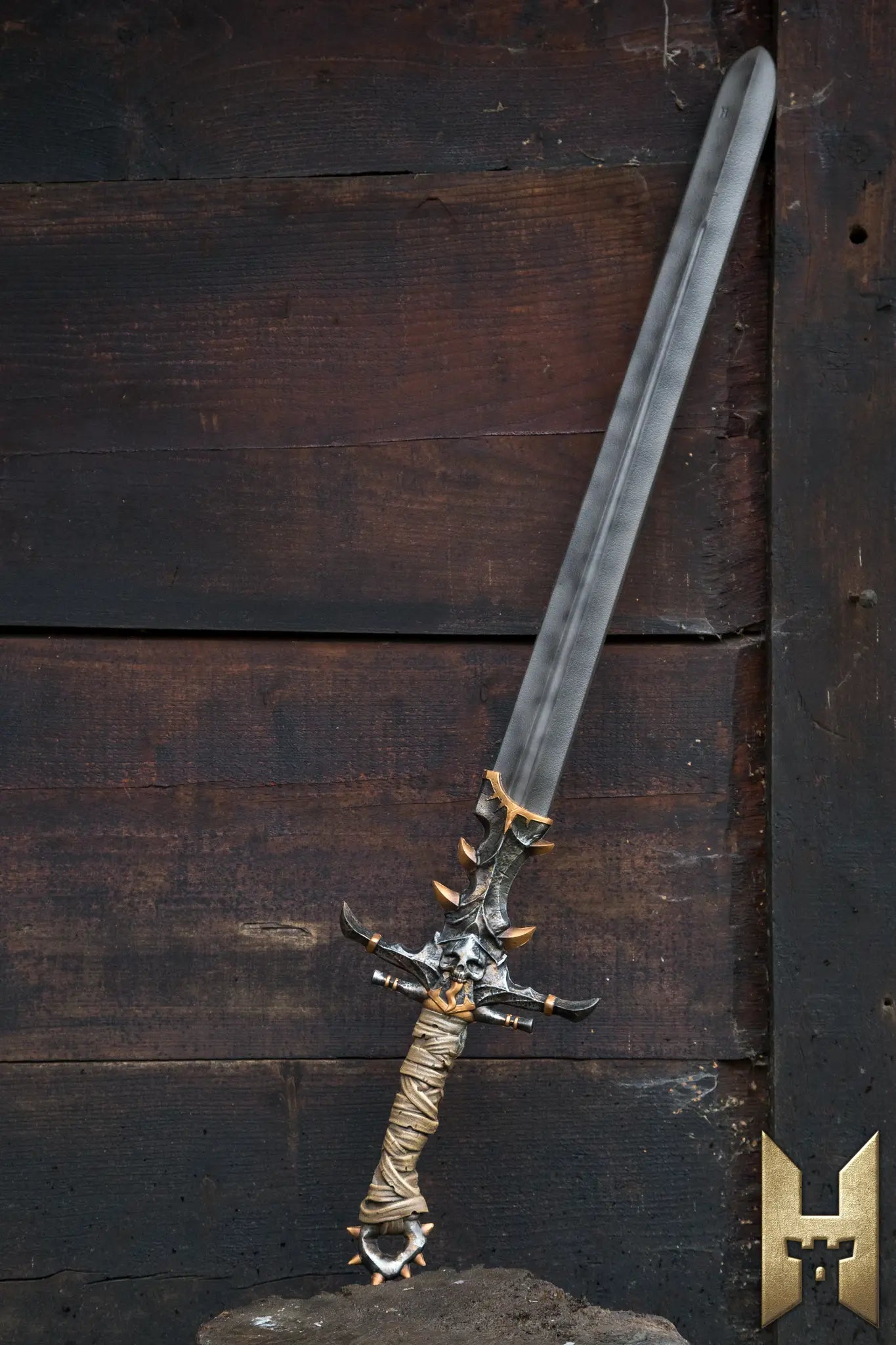 Marauder Sword displayed against a rustic wooden background, showcasing its intricate design and craftsmanship.