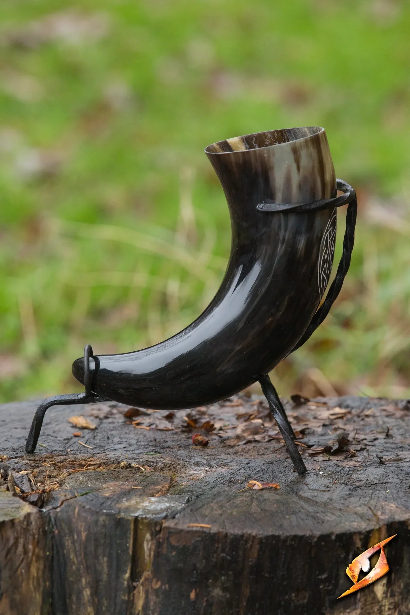 Aegishjalmur Horn With Stand displayed on a log, crafted from genuine bull horn, ideal for drinking.