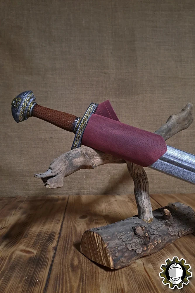 Sword Holder (New Blood) displaying a sword in a functional scabbard on a rustic wood stand.