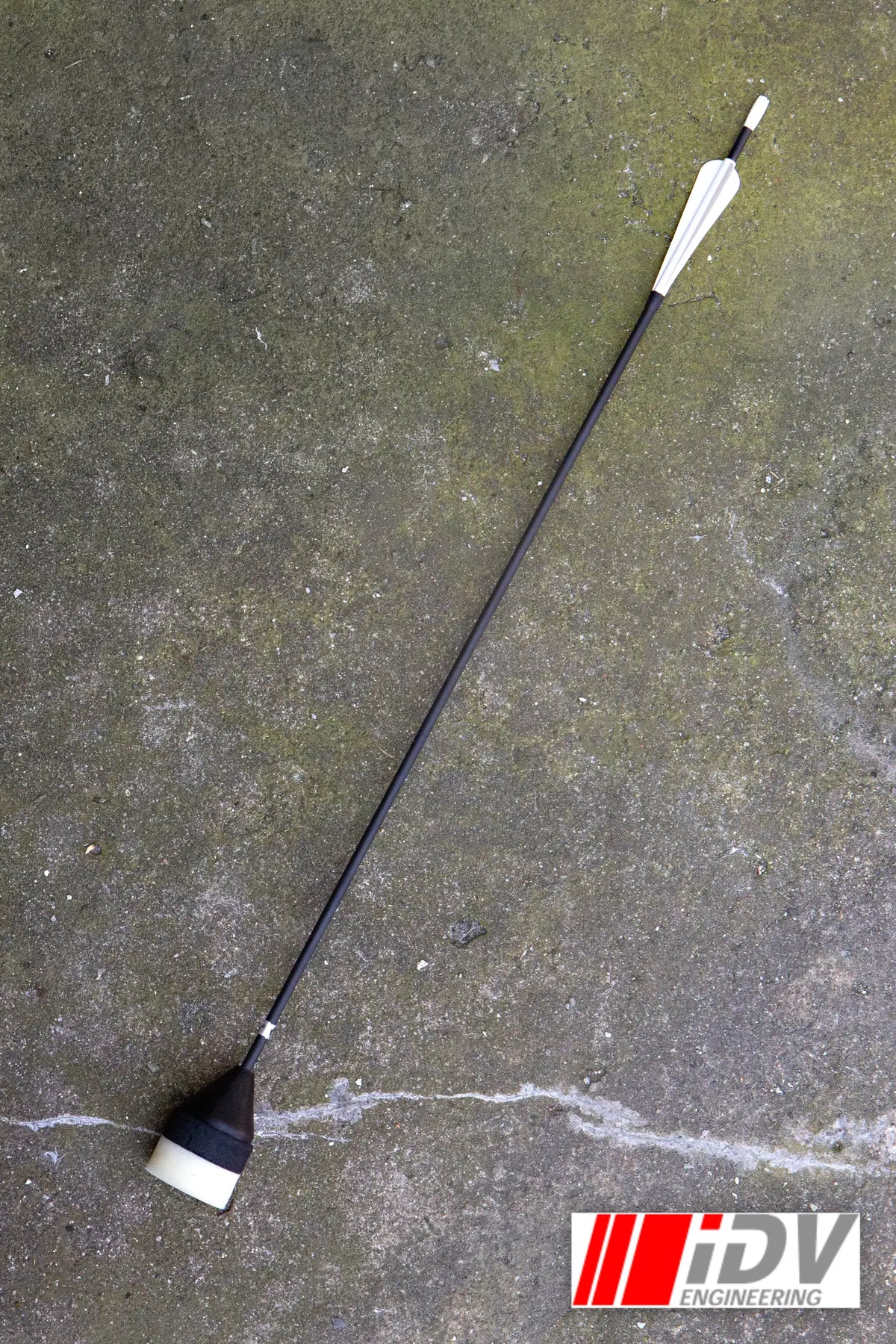 Arrow - Flat Head - Sleeved lying on a concrete surface, showcasing its sleek design and features.