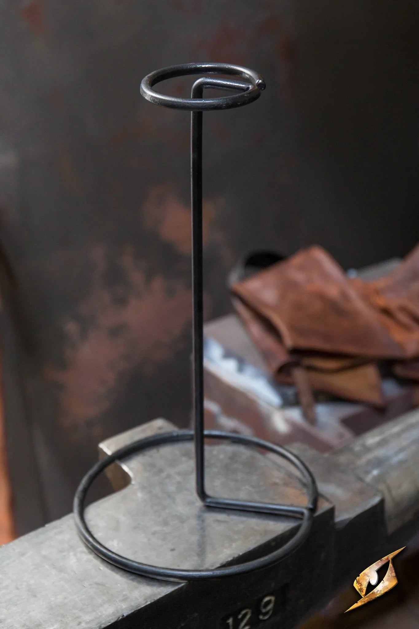 Helmet Stand Metal - Black displayed on a surface, showcasing its sturdy and elegant design.