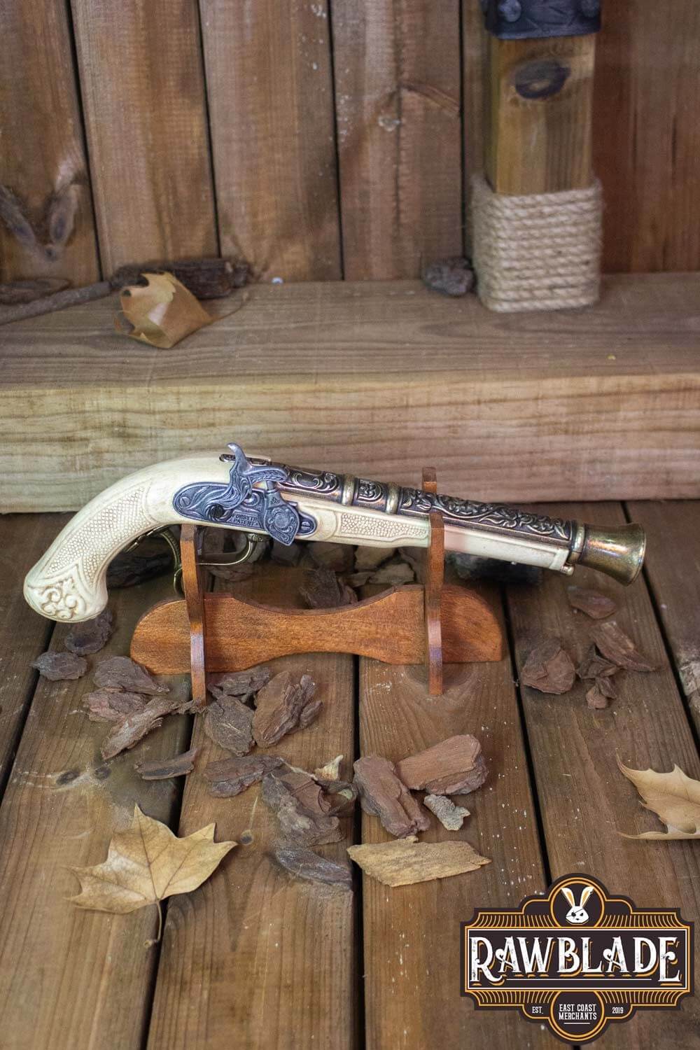 Thunder Gun displayed on wooden stand with autumn leaves, showcasing its detailed metal and resin design.
