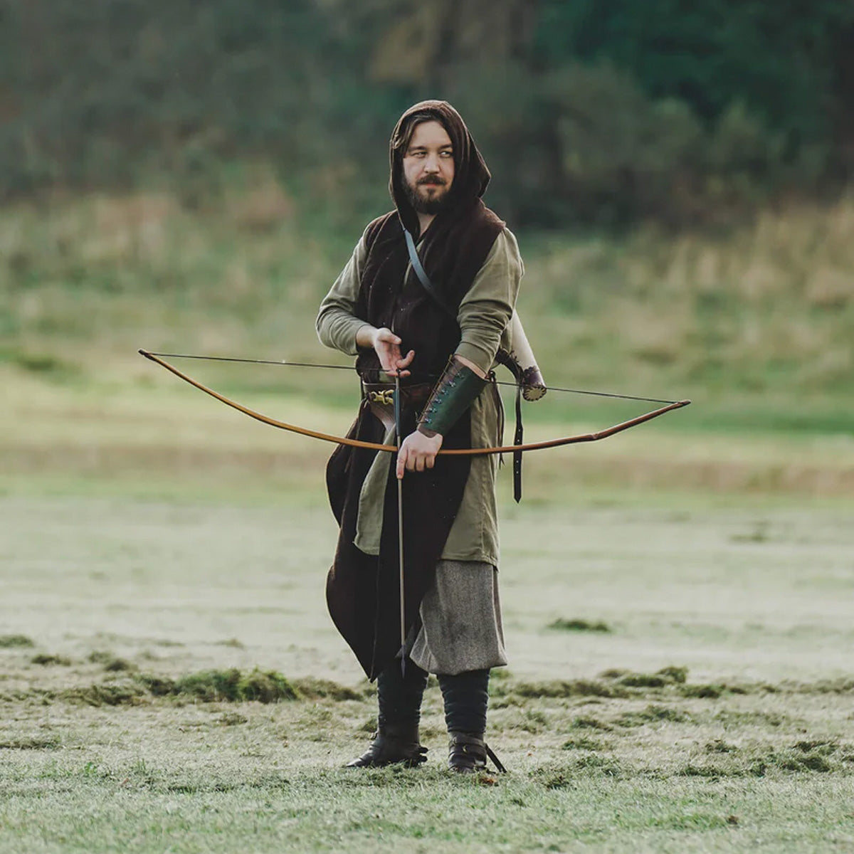 11 LARP costumes you can build with Epic Armoury gear featuring a character with a bow in a forest setting.