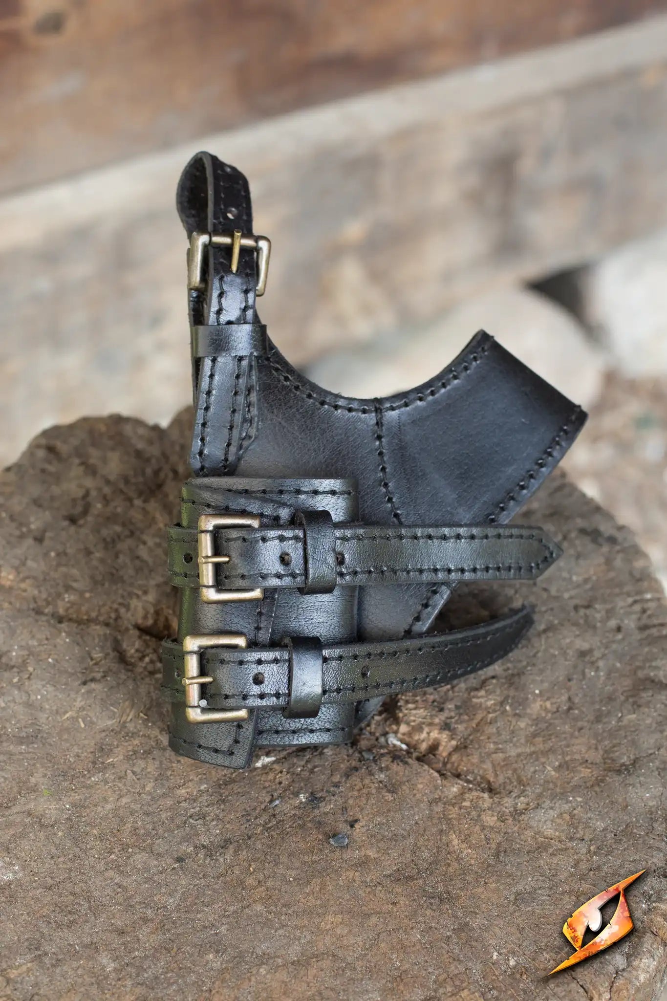 Adventurer Swordholder displayed on a rocky surface, showcasing its sturdy leather design and adjustable buckles.