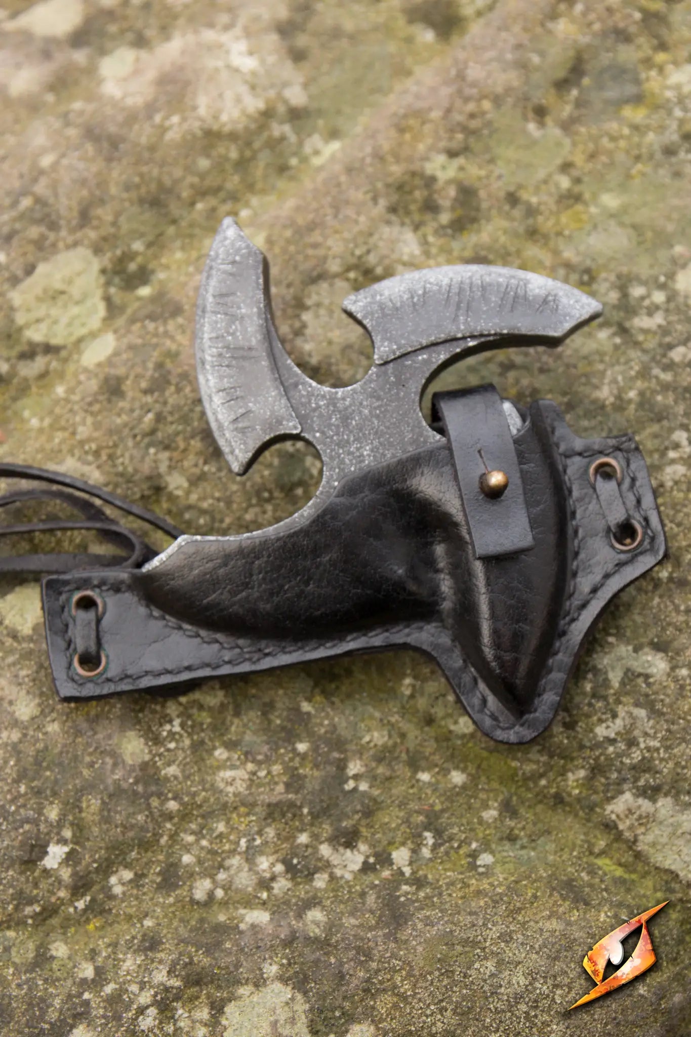 Black Shuriken & Holder with leather holder and two ties on a rocky surface.
