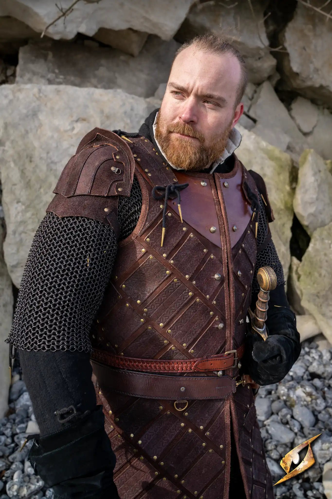 Woodsman Suede Shoulder Armour showcased on a male model in a rugged outdoor setting, highlighting its detailed craftsmanship.