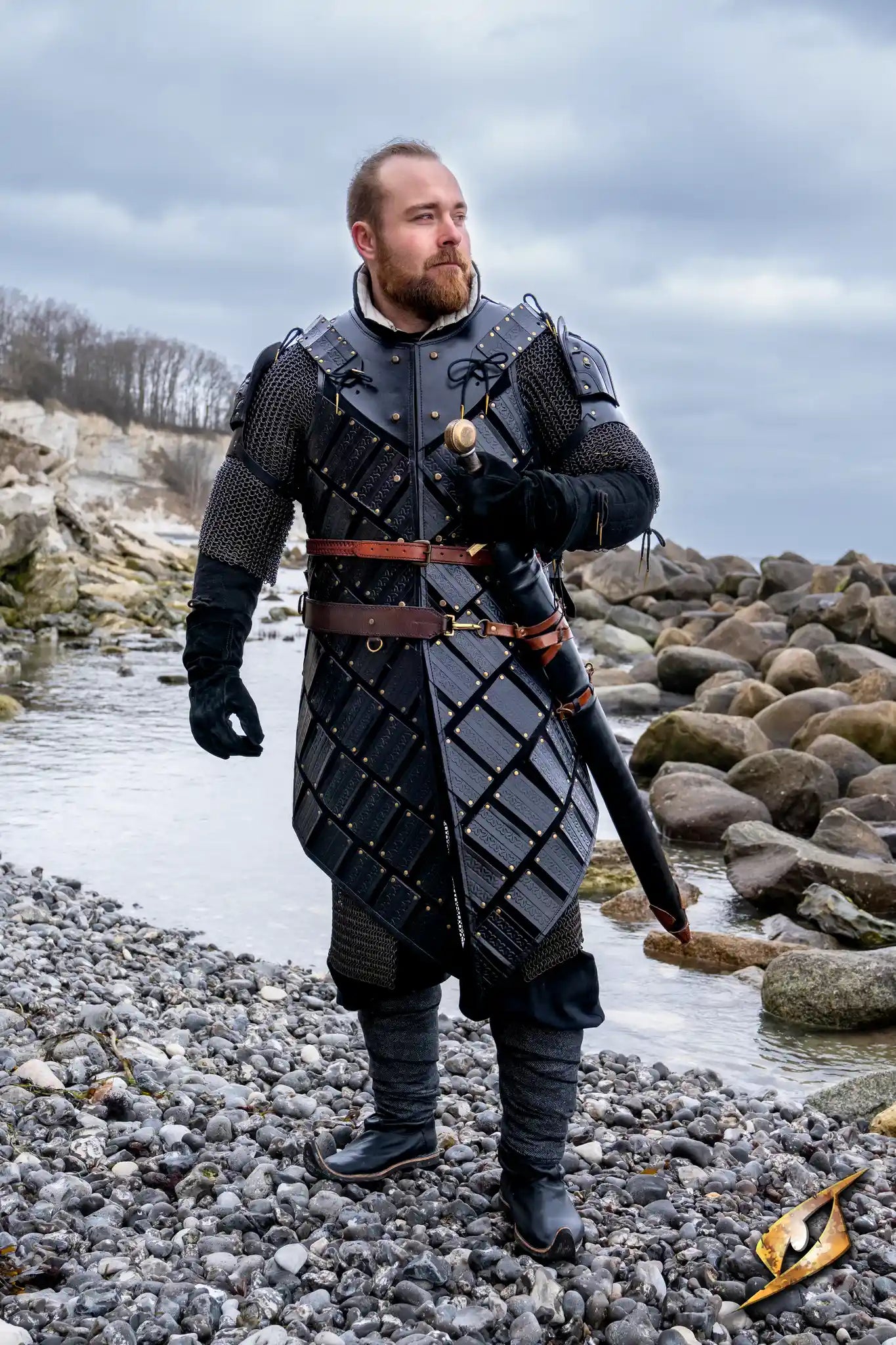 Woodsman Armour worn by a character by the water, showcasing the intricate leather design and Celtic patterns.