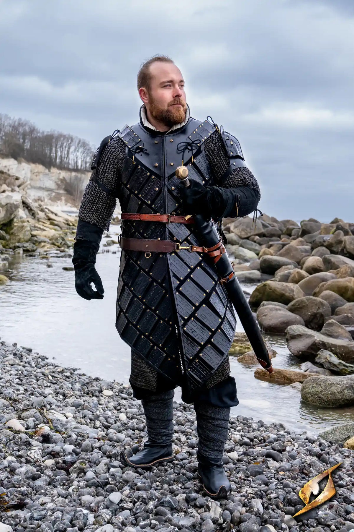 Woodsman Armour worn by a character by the water, showcasing the intricate leather design and Celtic patterns.