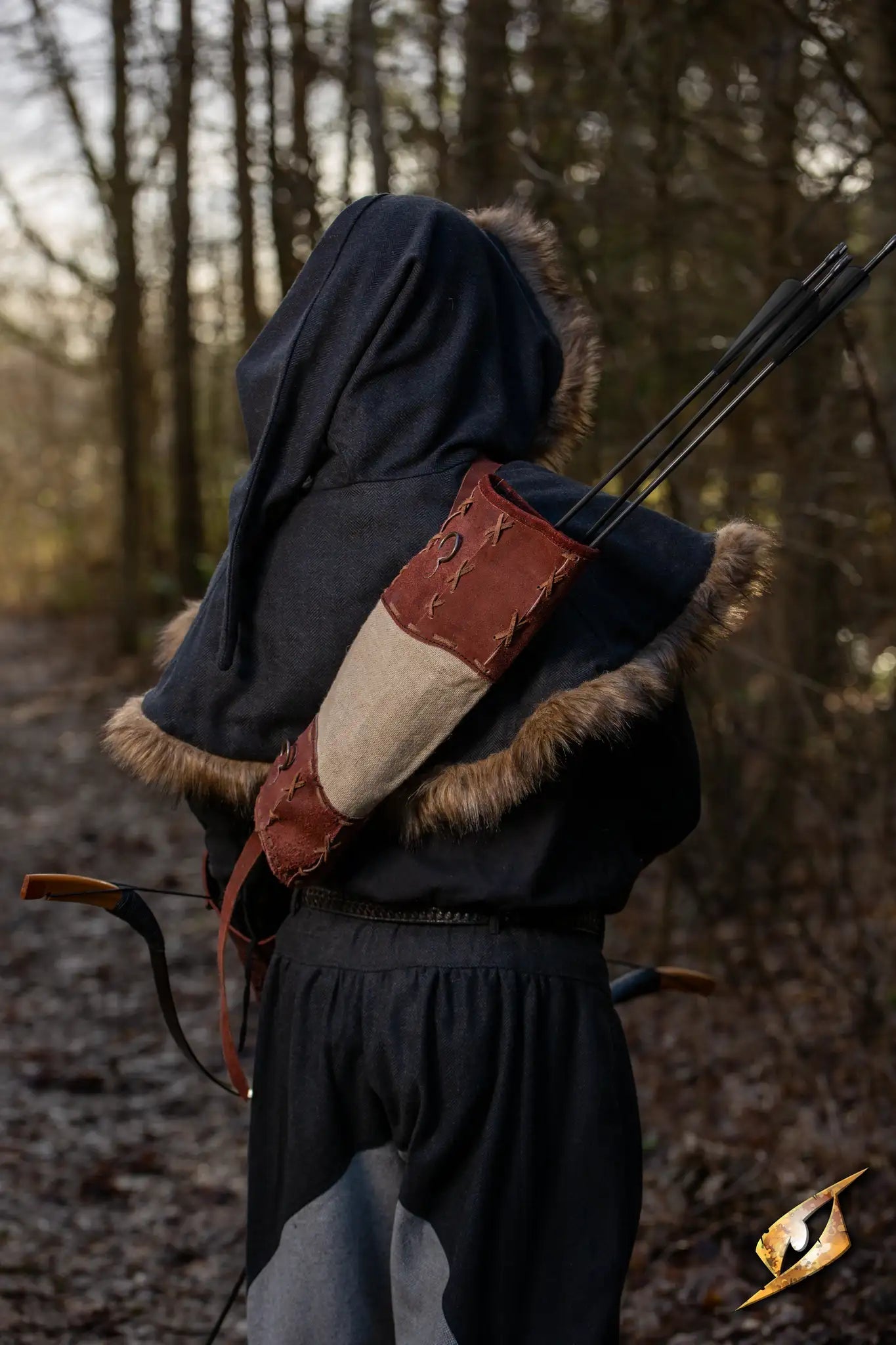 Wildling Quiver - Suede on an archer in a forest setting, showcasing its rustic design and color Ox Brown.