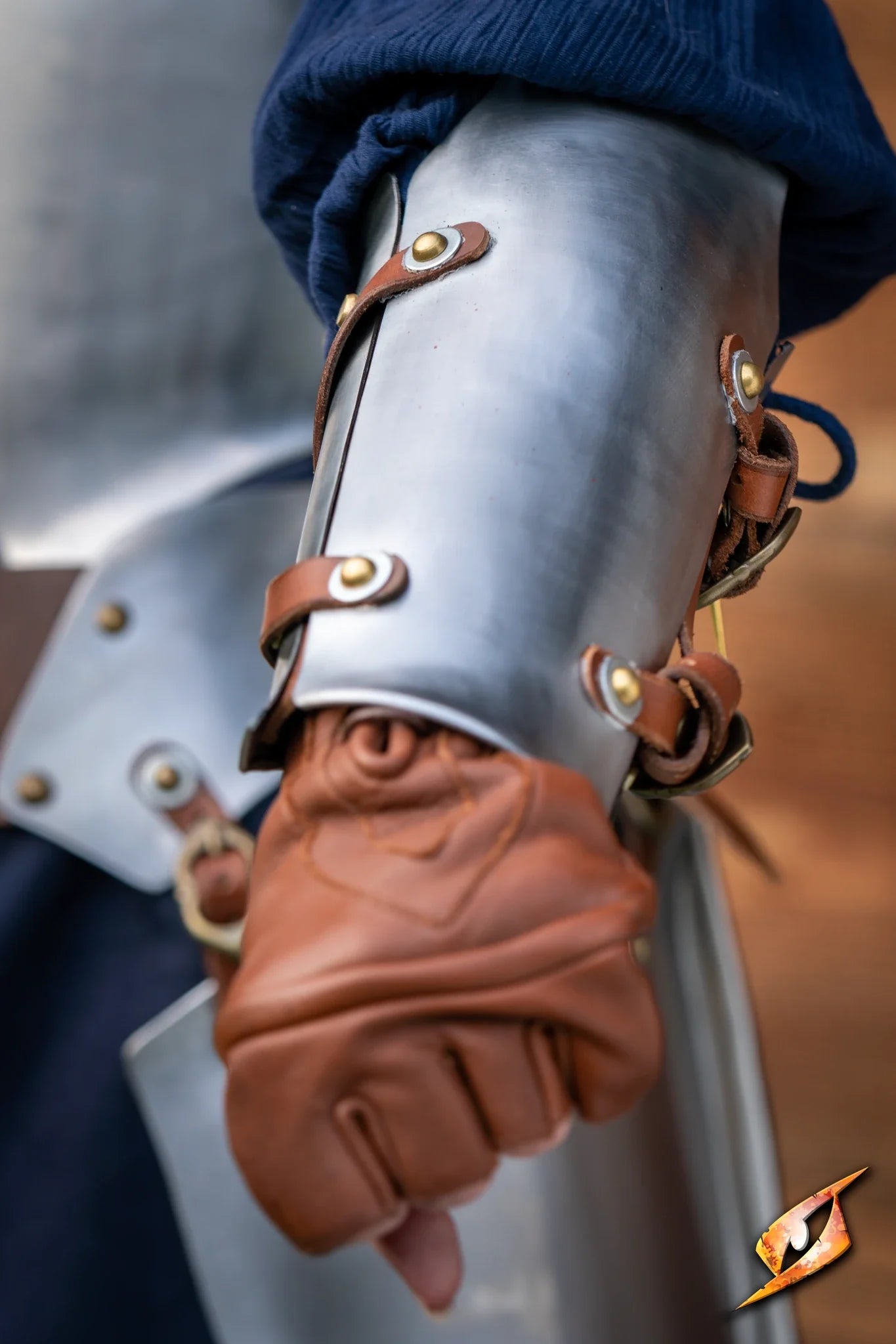 Close-up of Renegade Vambraces showcasing handcrafted steel design and leather gloves.