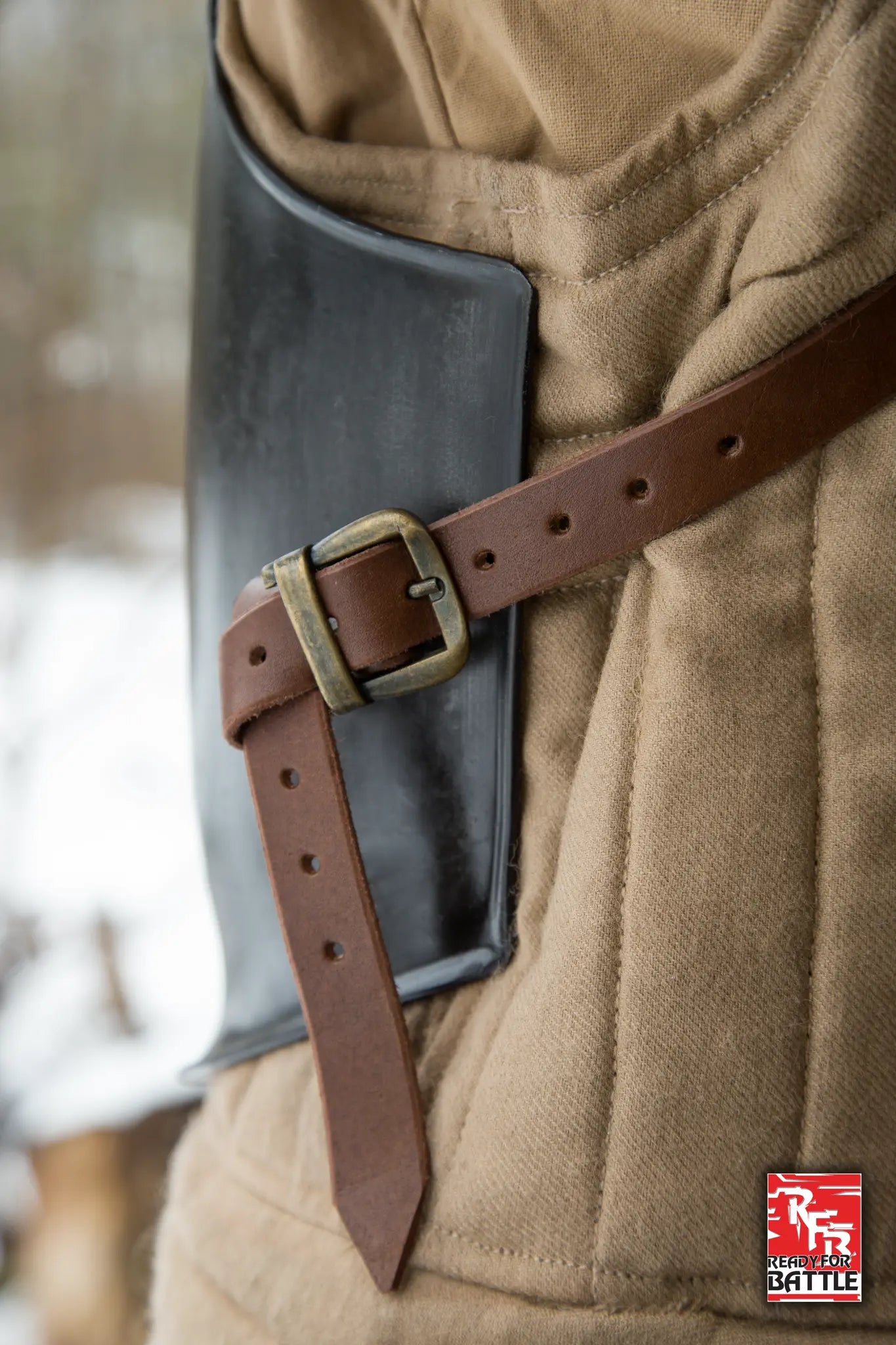 Close-up of an RFB Breastplate with a brown leather strap, showcasing durable design for tactical soldiers.