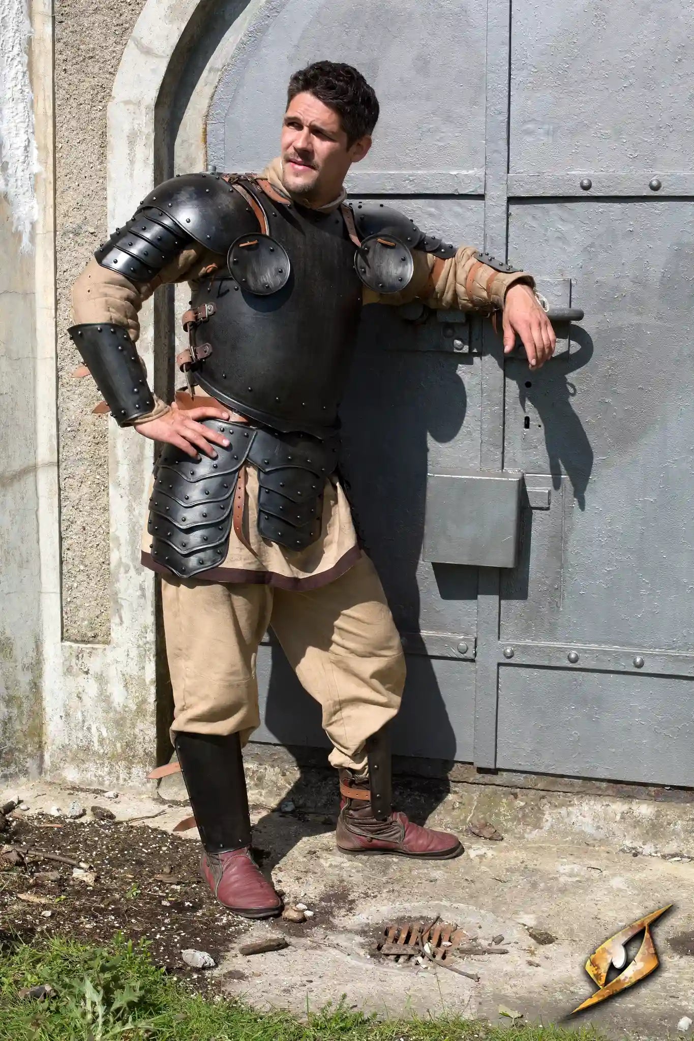 2Q - Dark Warrior Complete Set - Large worn by a man leaning against a stone wall with armor and medieval attire.