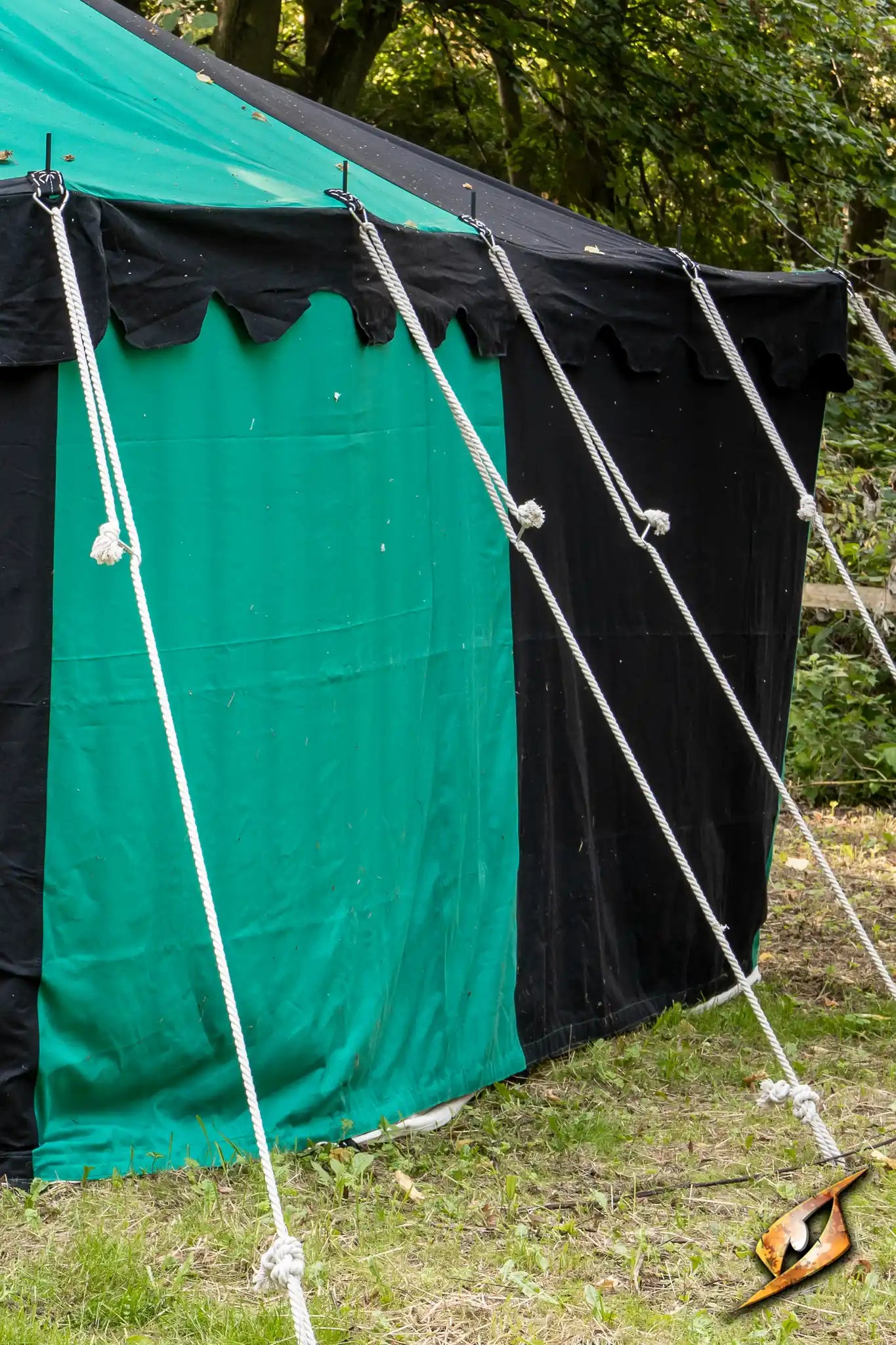 Marquee Tent - Sides - 5x8m with ropes securing the sidewall and tent in a natural setting.