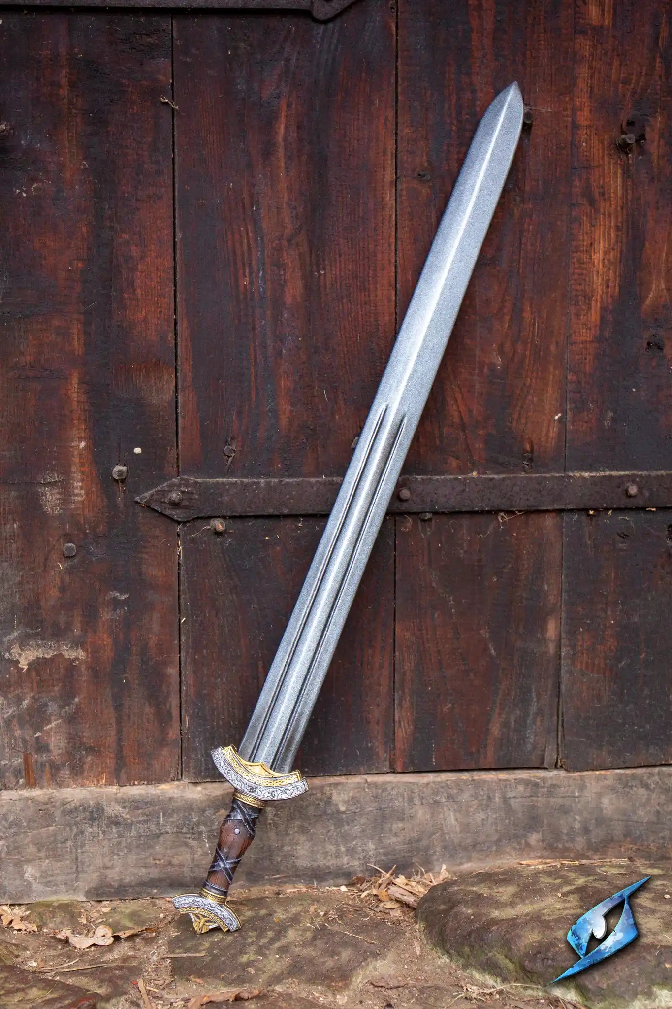 Warlord Sword displayed against a rustic wooden background, showcasing its double fuller and Nordic-inspired ornamentations.