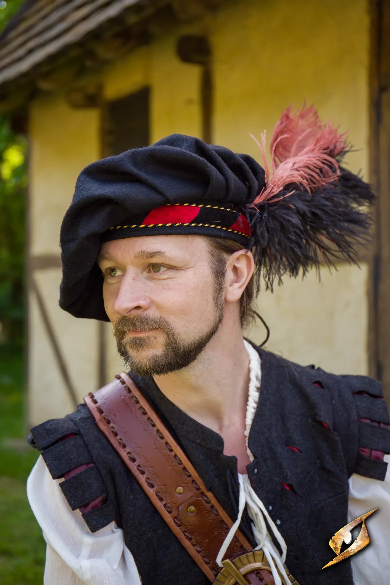 Wool Minstrel Hat worn by a man with a beard, featuring a feather and traditional attire.