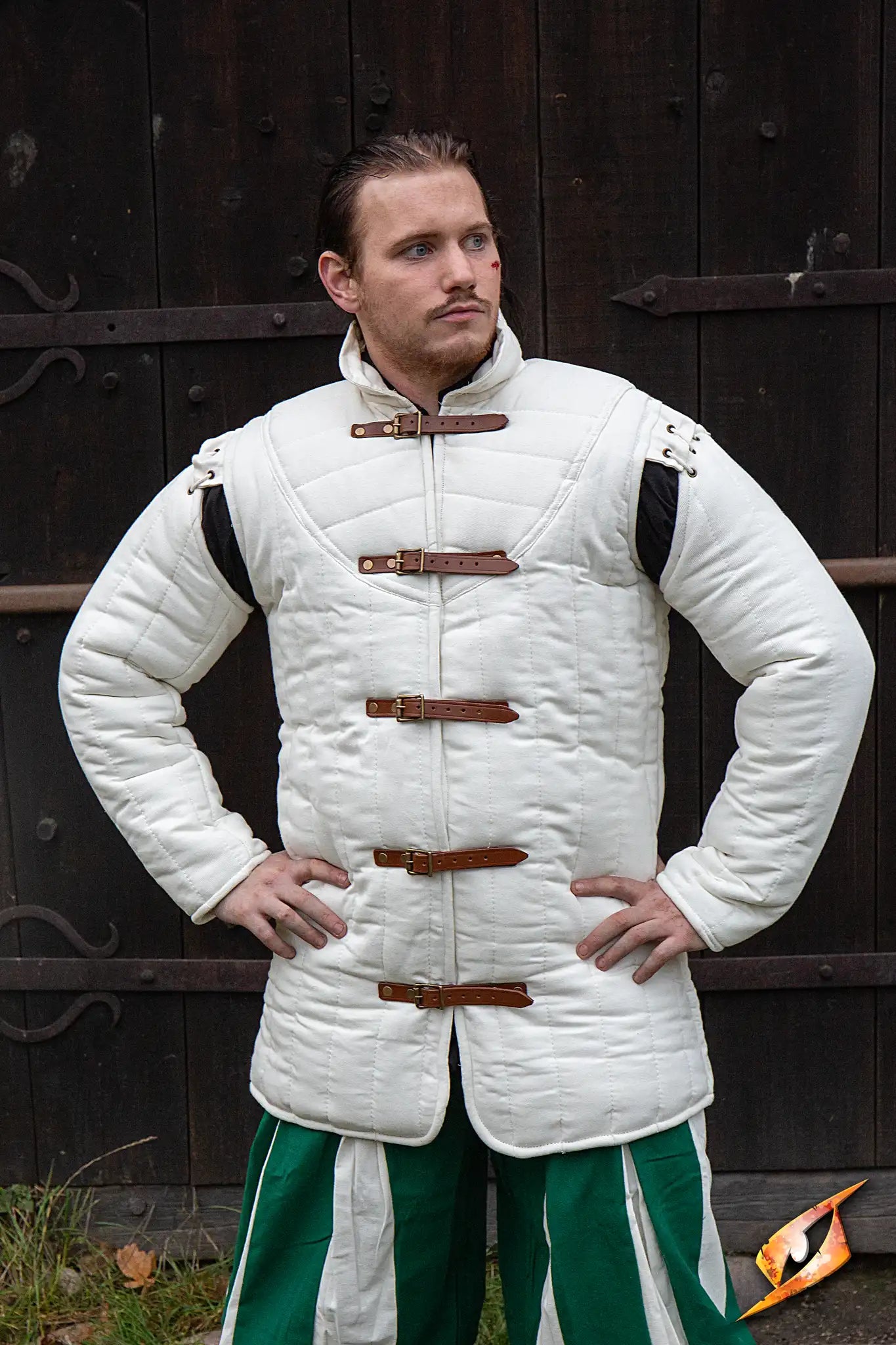 Gambeson Warrior With Long Sleeves worn by a model, featuring side buckles and a warm, quilted design.