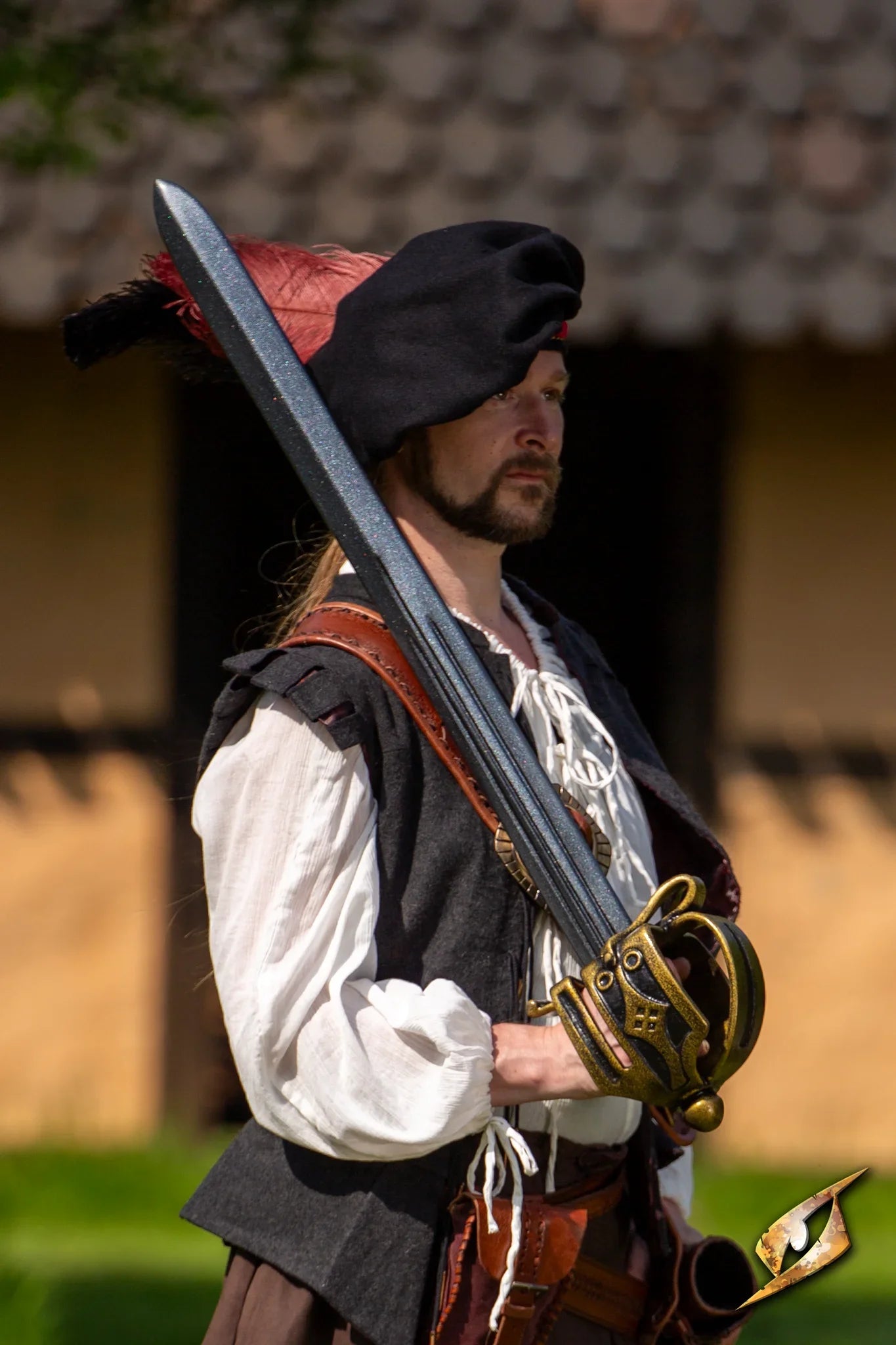 A man in historical attire poses with a Basket-hilted Broadsword, showcasing craftsmanship and historical significance.