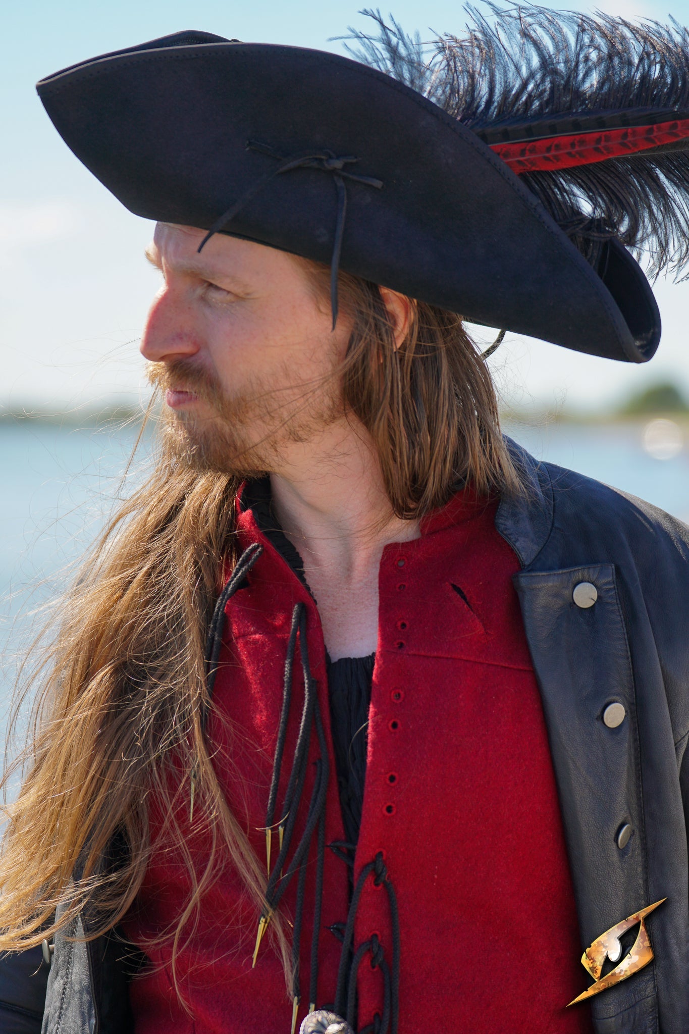 Simple Leather Pirate Tricorn Hat worn by a man with long hair, enhancing his pirate costume near the water.
