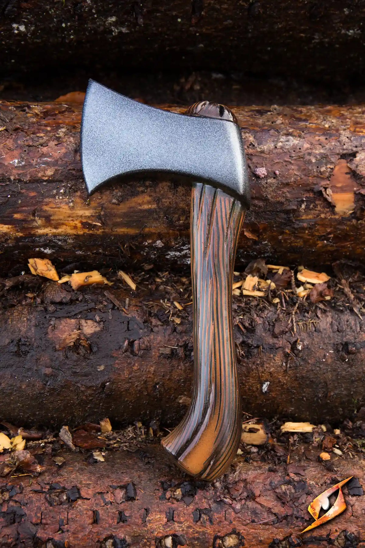 Axe - Franciscan resting on logs, showcasing its sharp blade and wooden handle in a natural setting.