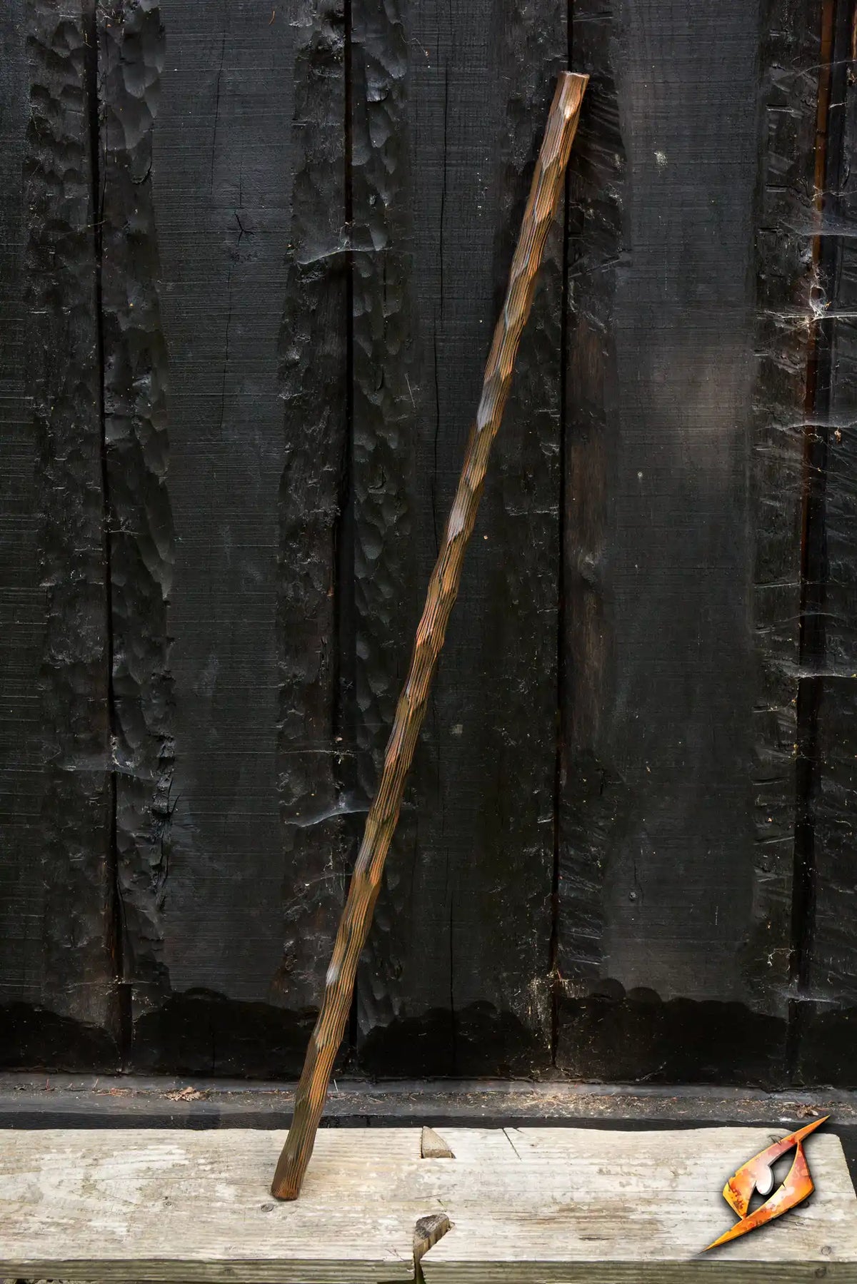 Wooden Quarterstaff showing a realistic carved woodgrain design against a dark wooden backdrop.