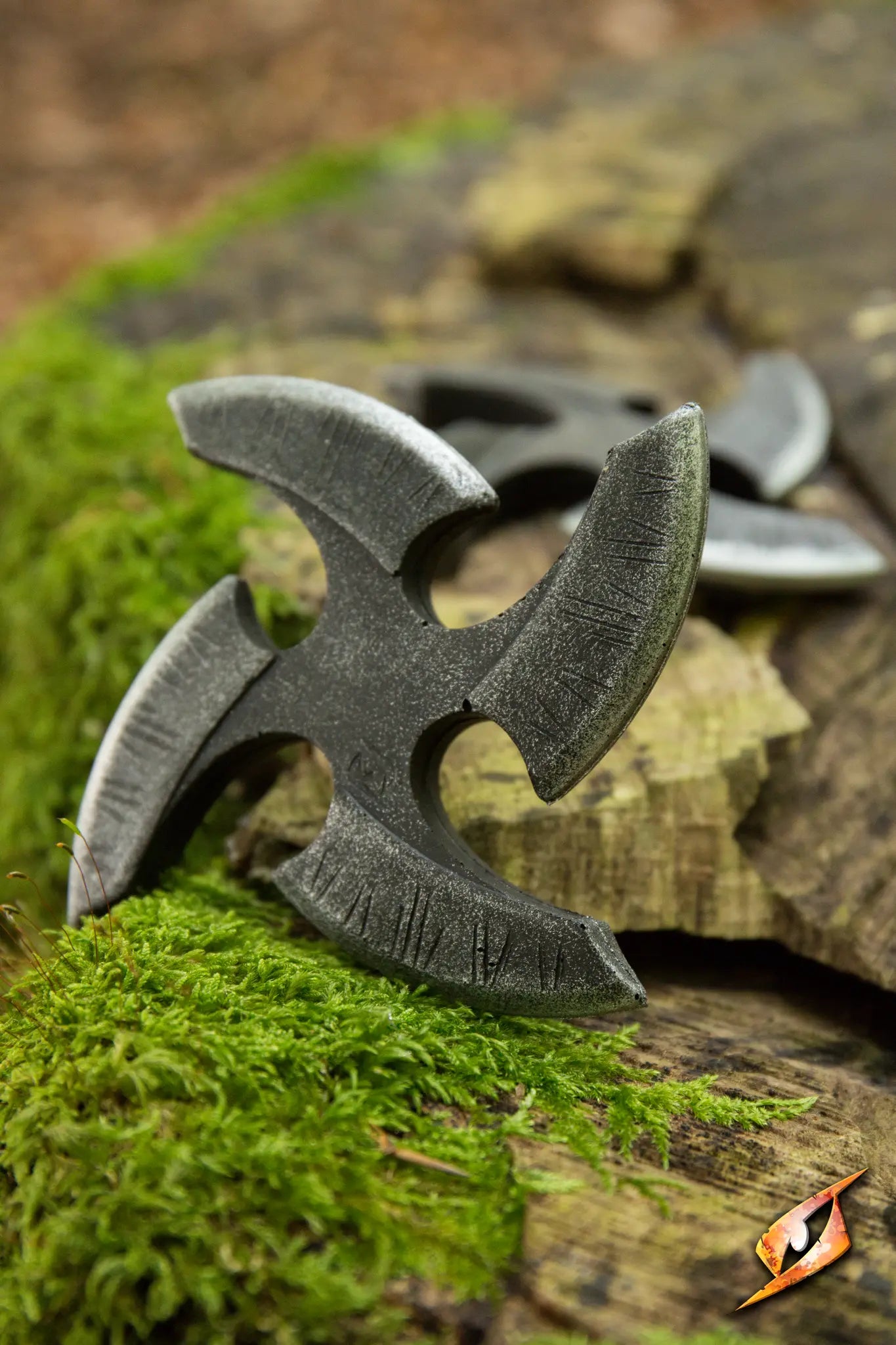 Black Shuriken on mossy wooden surface showcasing its sharp, handpainted blades.