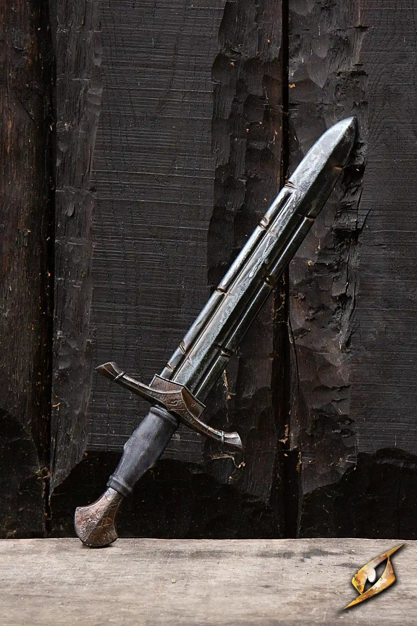 Battleworn Ranger Sword displayed against a dark wooden background, showcasing its battle-worn appearance.