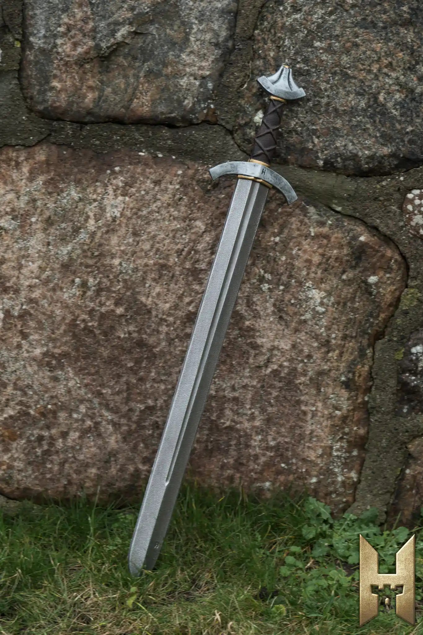 Stronghold Arming Sword leaning against a stone wall, perfect for LARP and cosplay adventures.