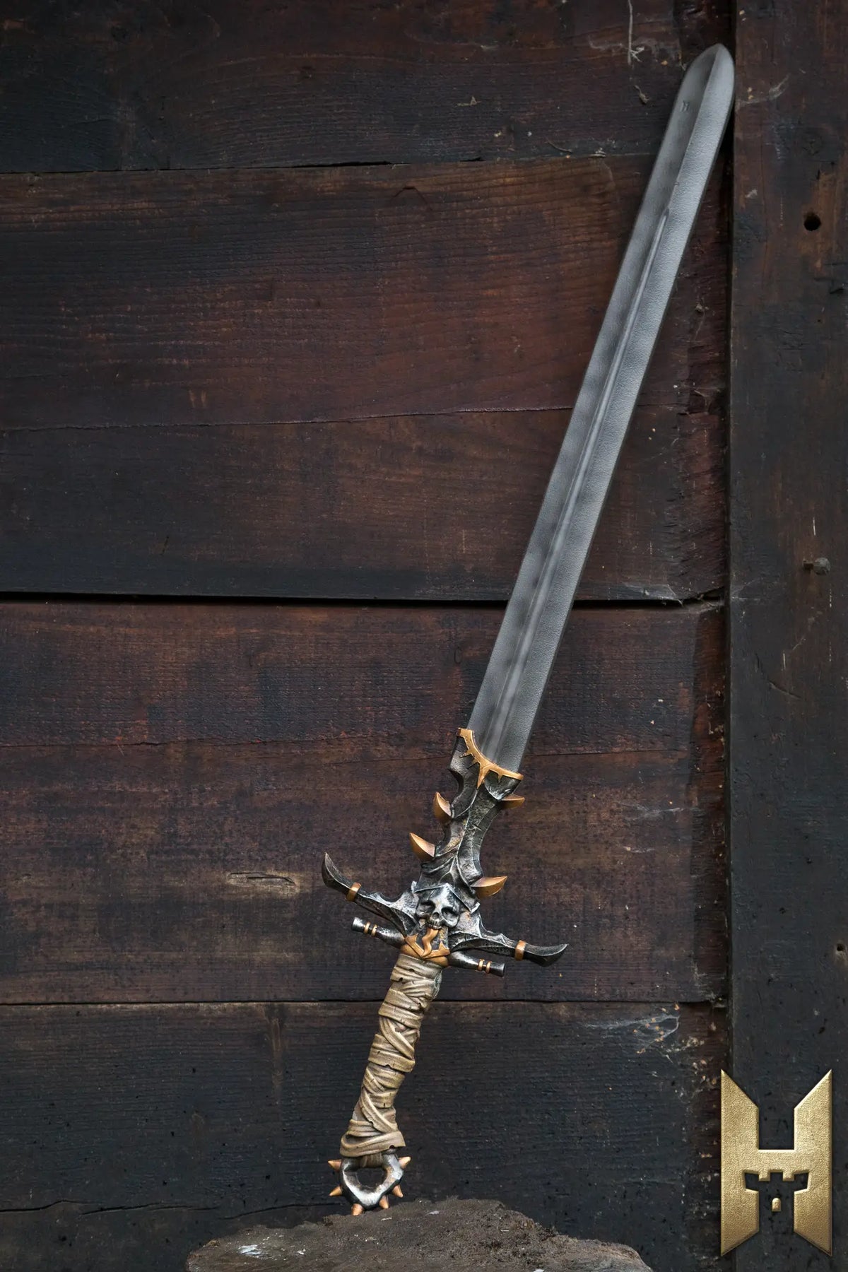 Marauder Sword displayed against a rustic wooden background, showcasing its intricate design and craftsmanship.