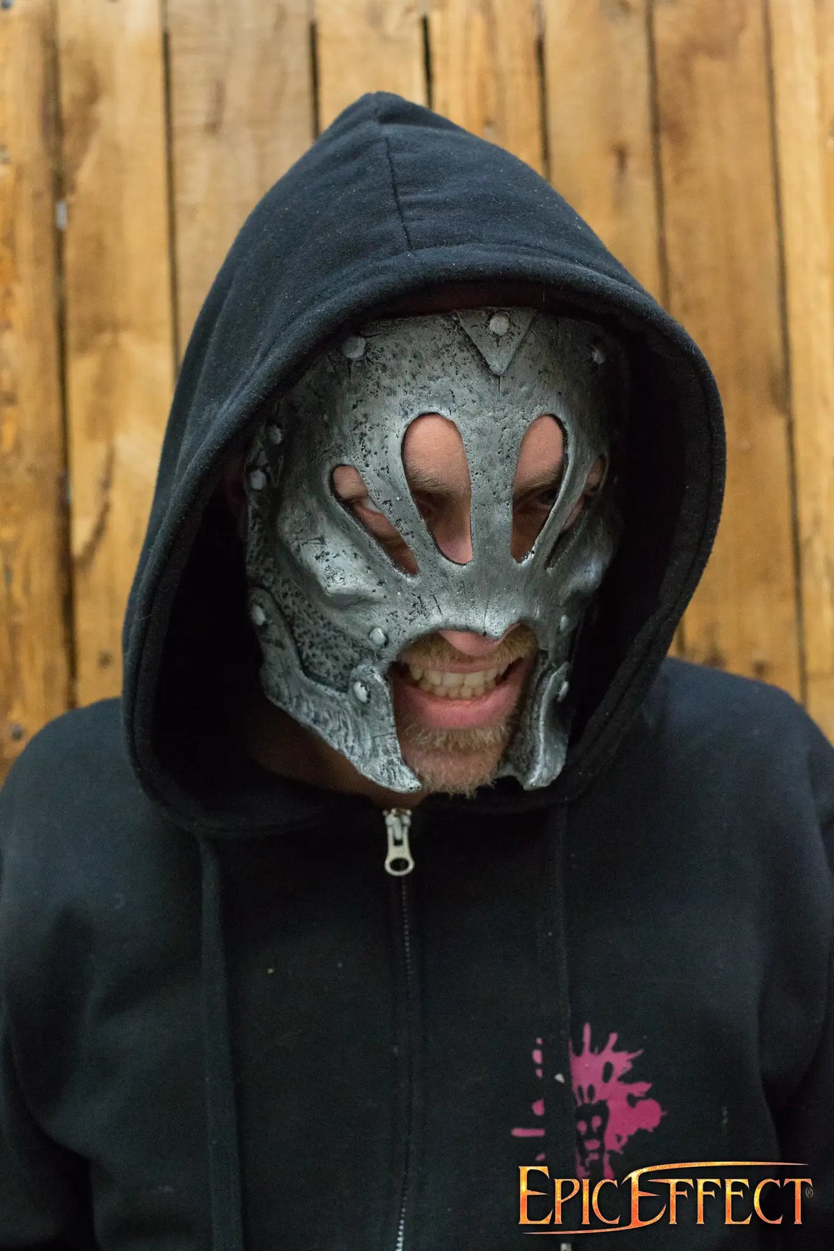 Berserker Trophy Mask worn by a person, featuring detailed sculpted rivets and a textured, metallic finish.