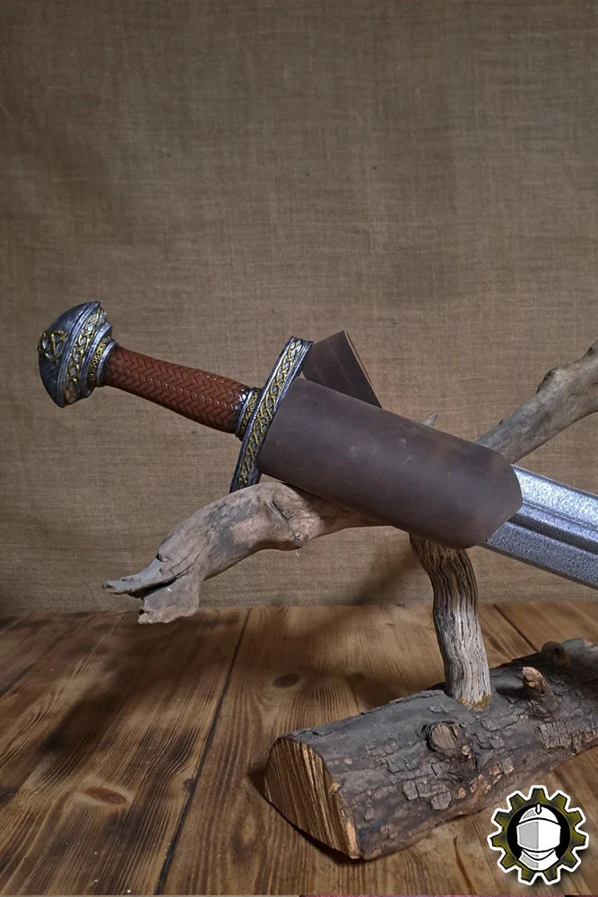 Sword Holder (New Blood) displayed with LARP sword on a rustic wooden stand, showcasing its functional design.