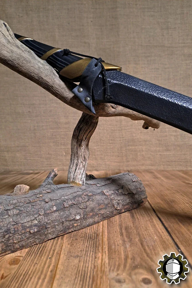 Blade Hook (New Blood) displayed on a rustic log stand highlighting its unique design and functionality.