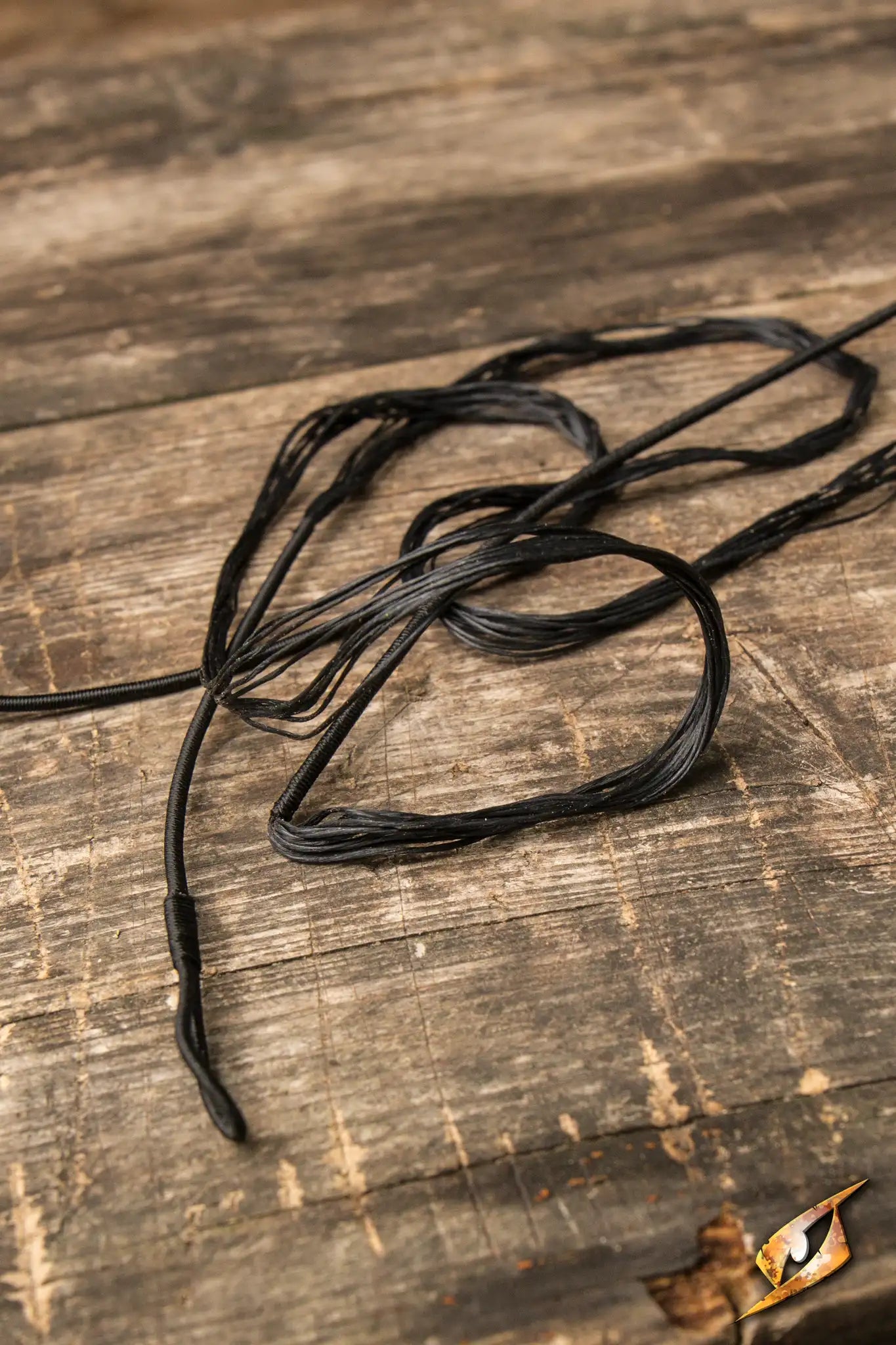Bow String used as a replacement for Epic Armoury’s 141 cm Medium LARP Flatbow on a wooden surface.