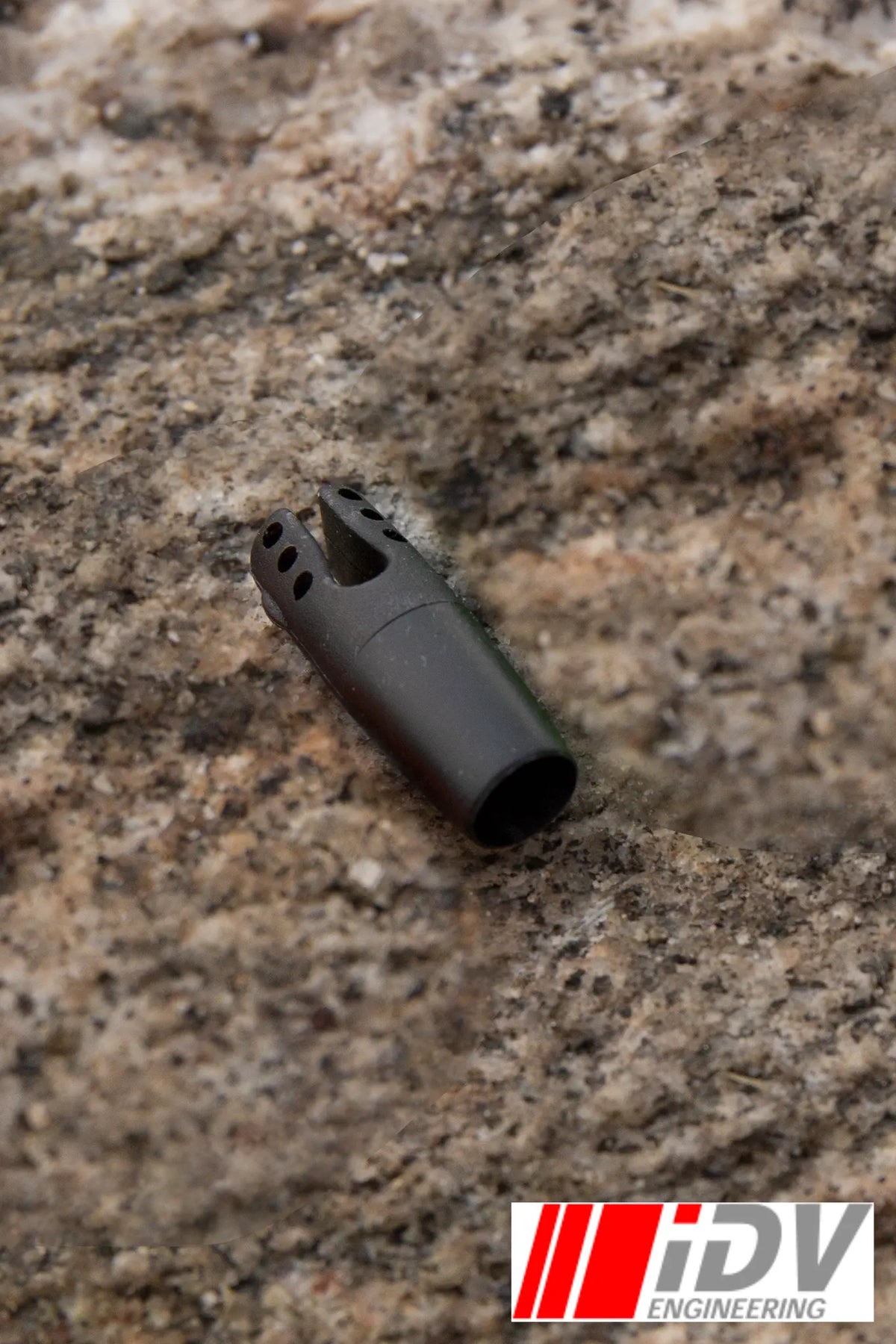 Nock for Larp Arrows by iDV Engineering in black color on a natural stone background.