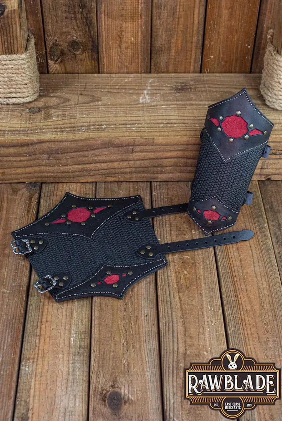 Beljant Bracer displayed on wooden surface with red accents and buckles.